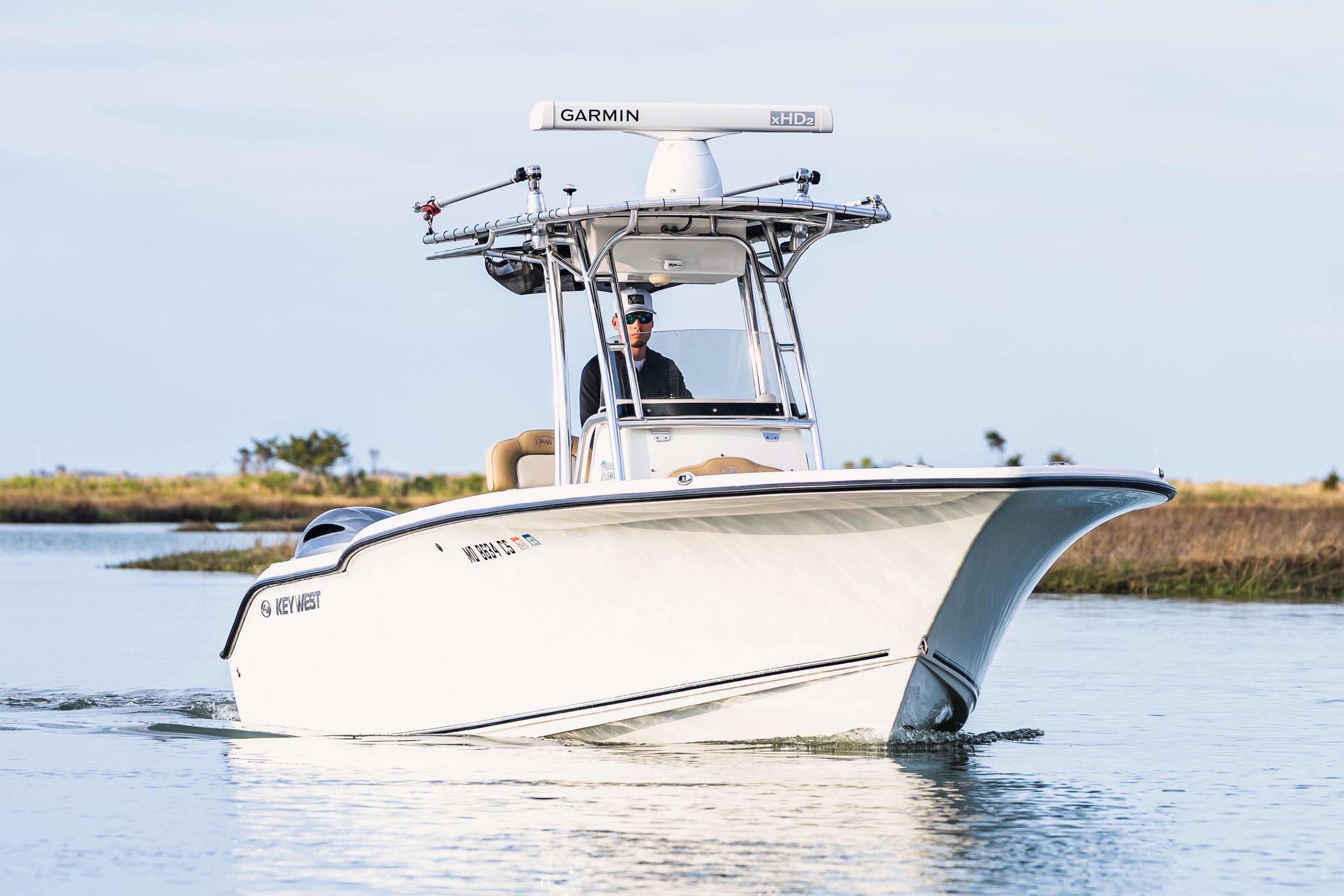 2018 Key West 244 Center Console boat on calm water.