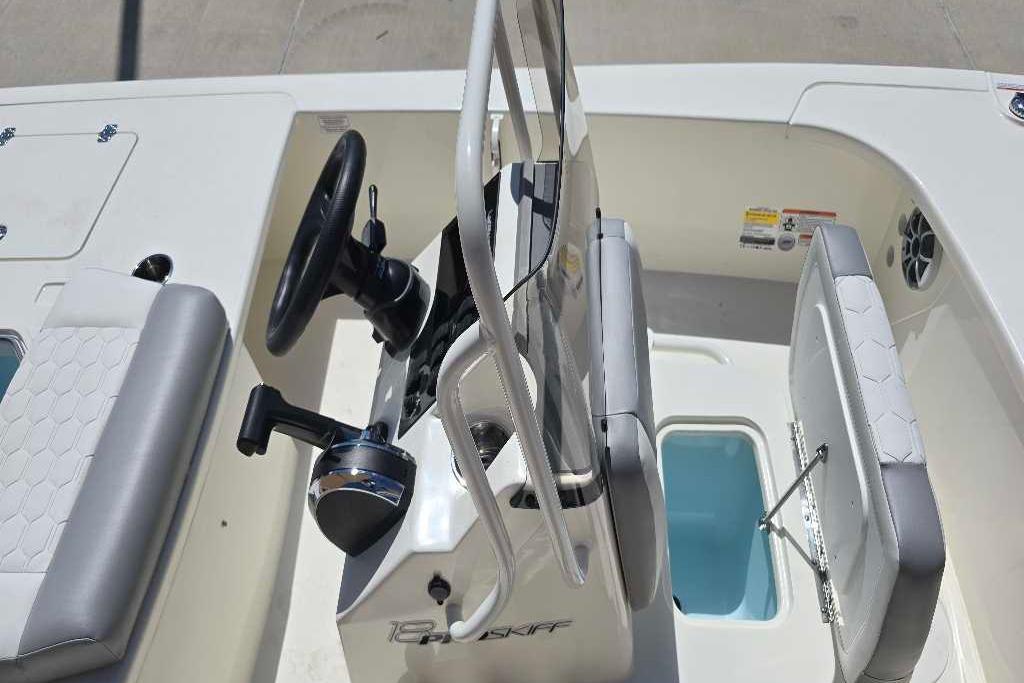 2026 Mako 18 Pro Skiff boat interior with steering wheel and seating.