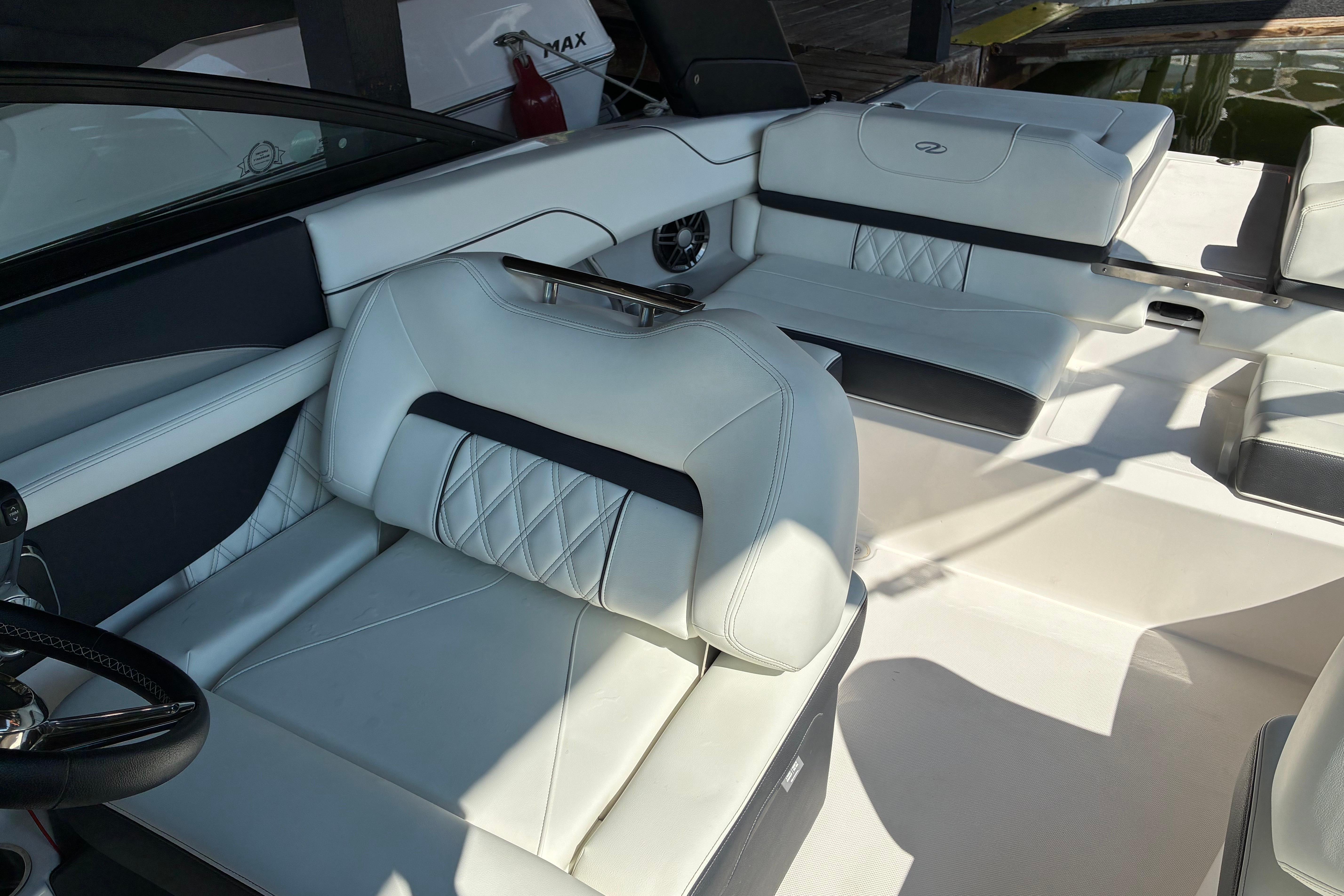 Luxurious interior of 2025 Regal LS2 boat with white leather seating.
