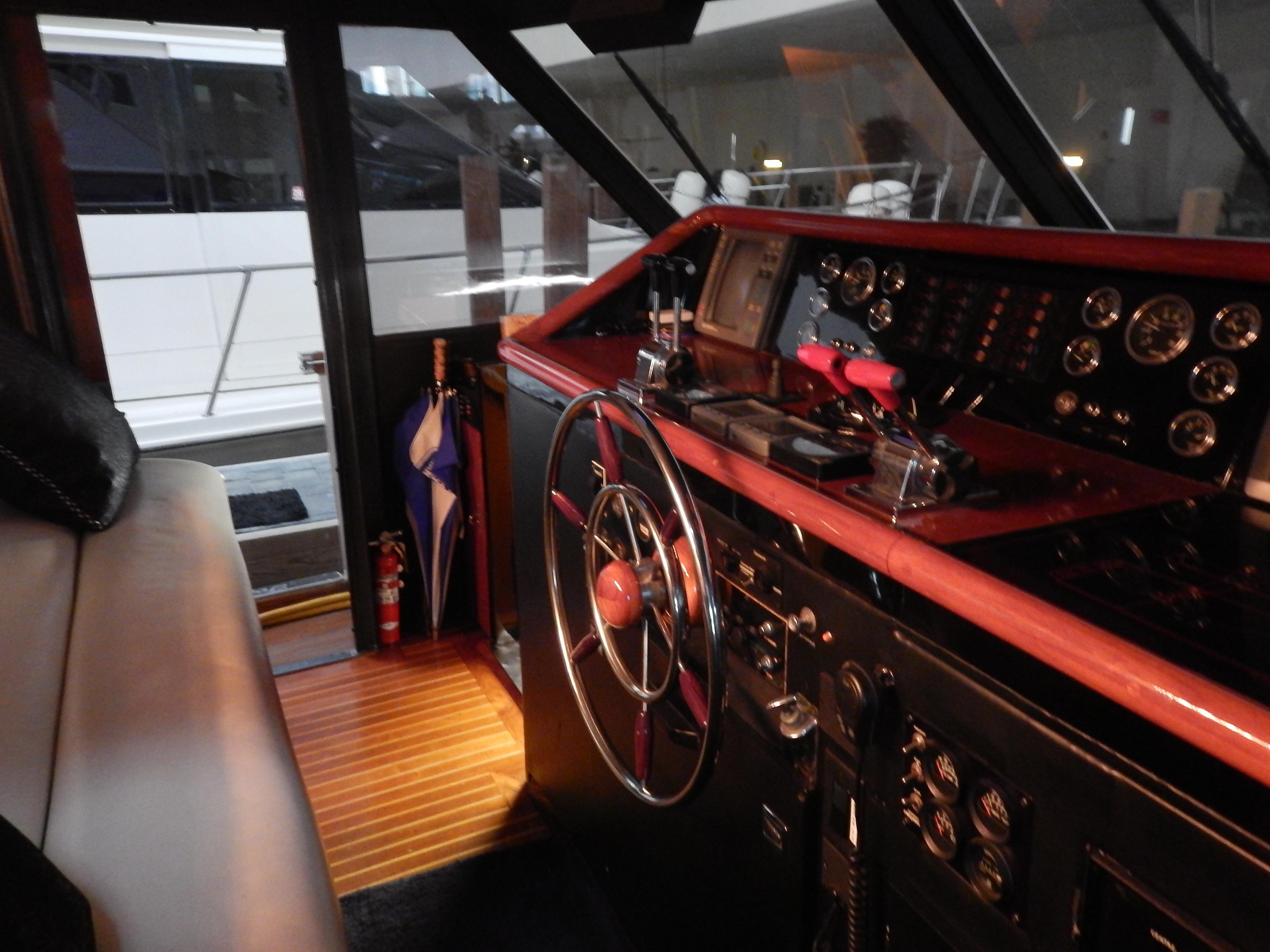 1974 Pacemaker Cockpit Motoryacht interior with classic steering wheel and control panel.