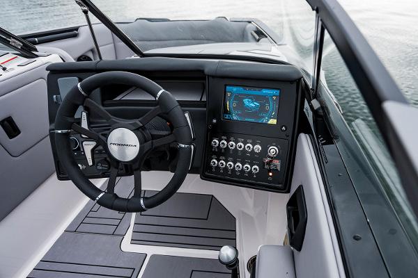 Manufacturer Provided Image: 2026 Moomba Max boat dashboard with steering wheel and digital display on water.