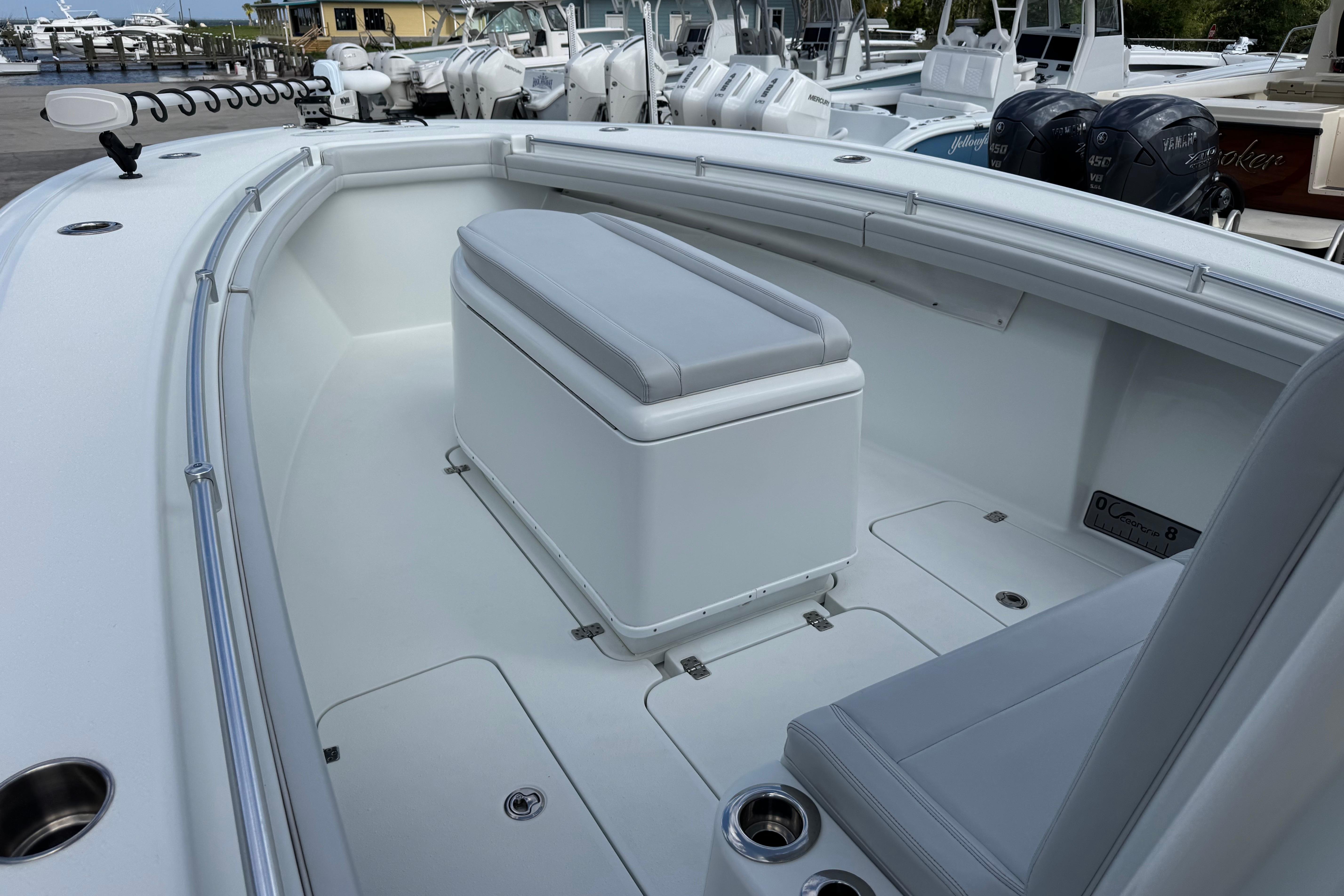2022 Yellowfin 32 Offshore boat interior with seating and storage, docked at marina.