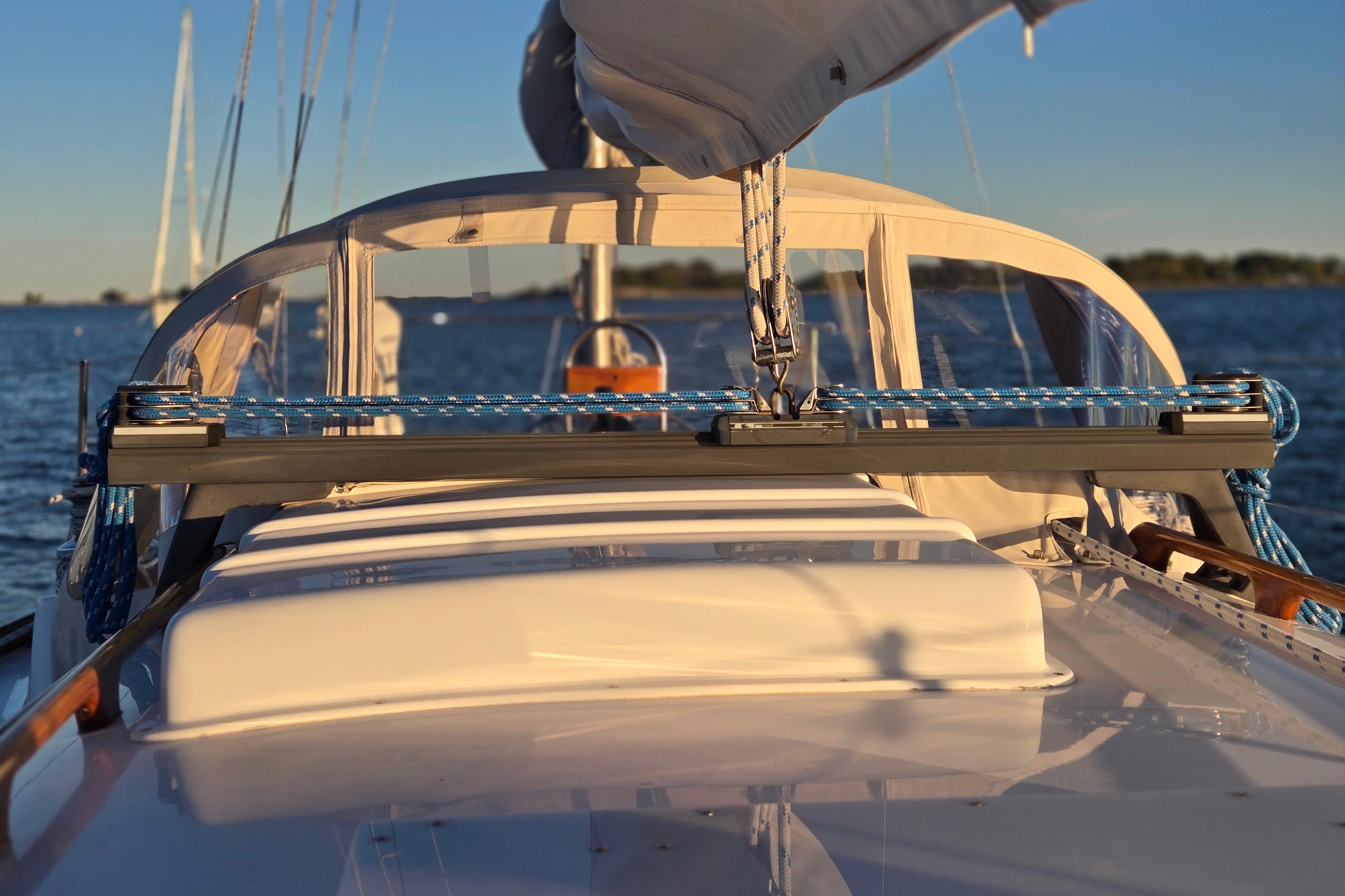 1970 Hinckley Bermuda 40 sailboat deck with ropes and clear sky background.