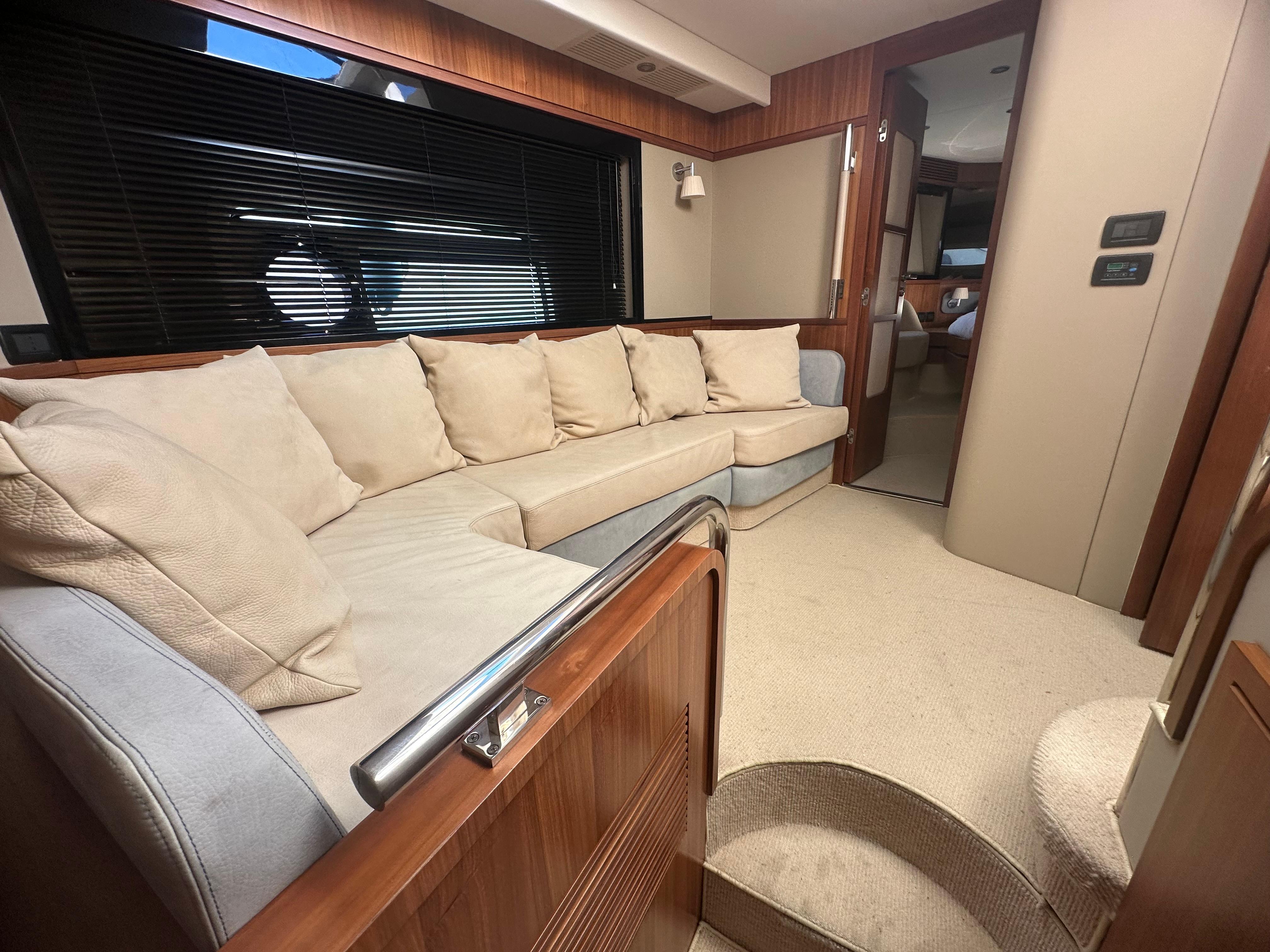 Luxurious interior of 2014 Azimut Magellano 50 yacht with plush seating and elegant design.