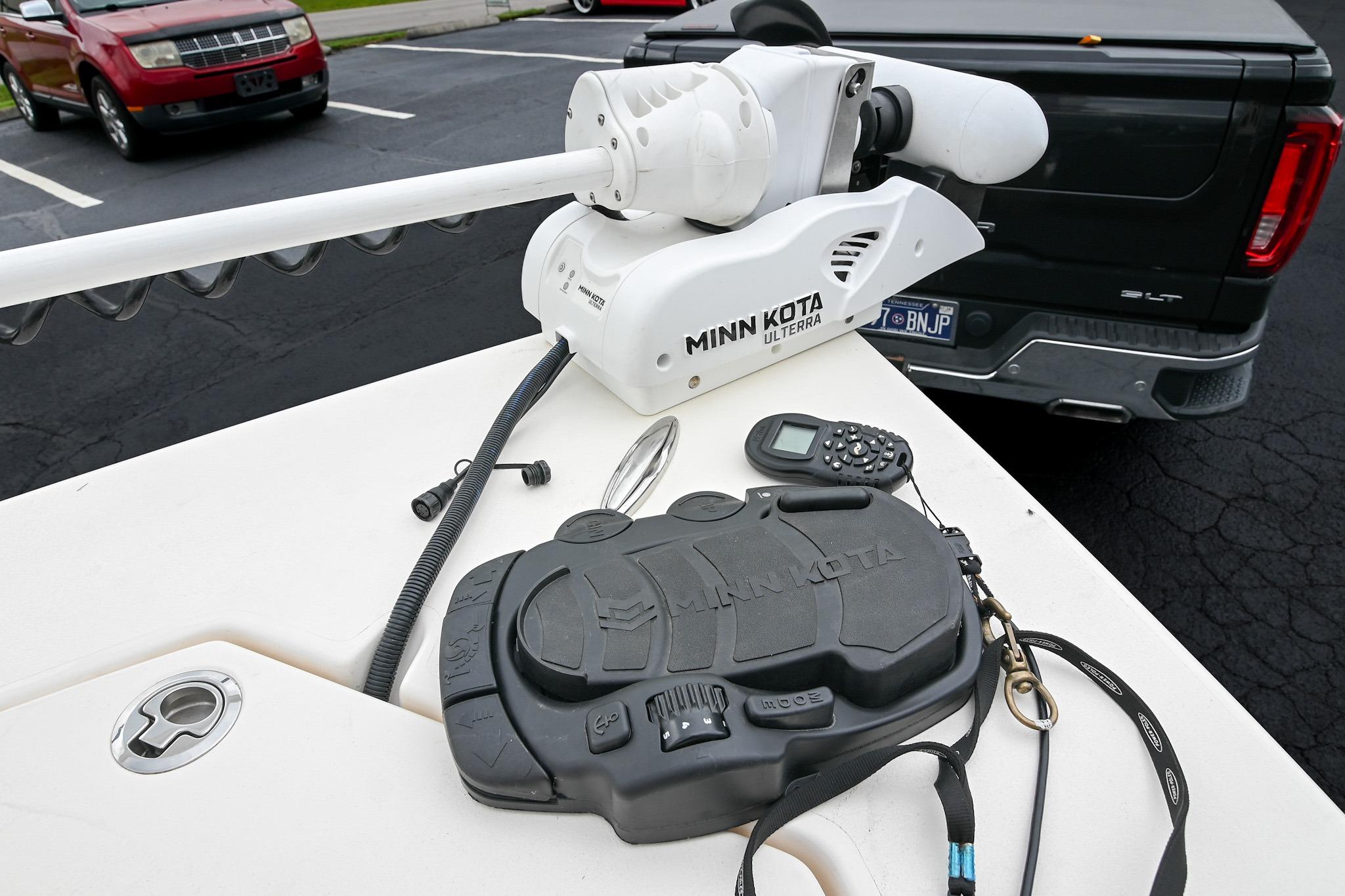 Minn Kota Ulterra motor on 2021 Pathfinder 2200 TRS boat, parked near vehicles.