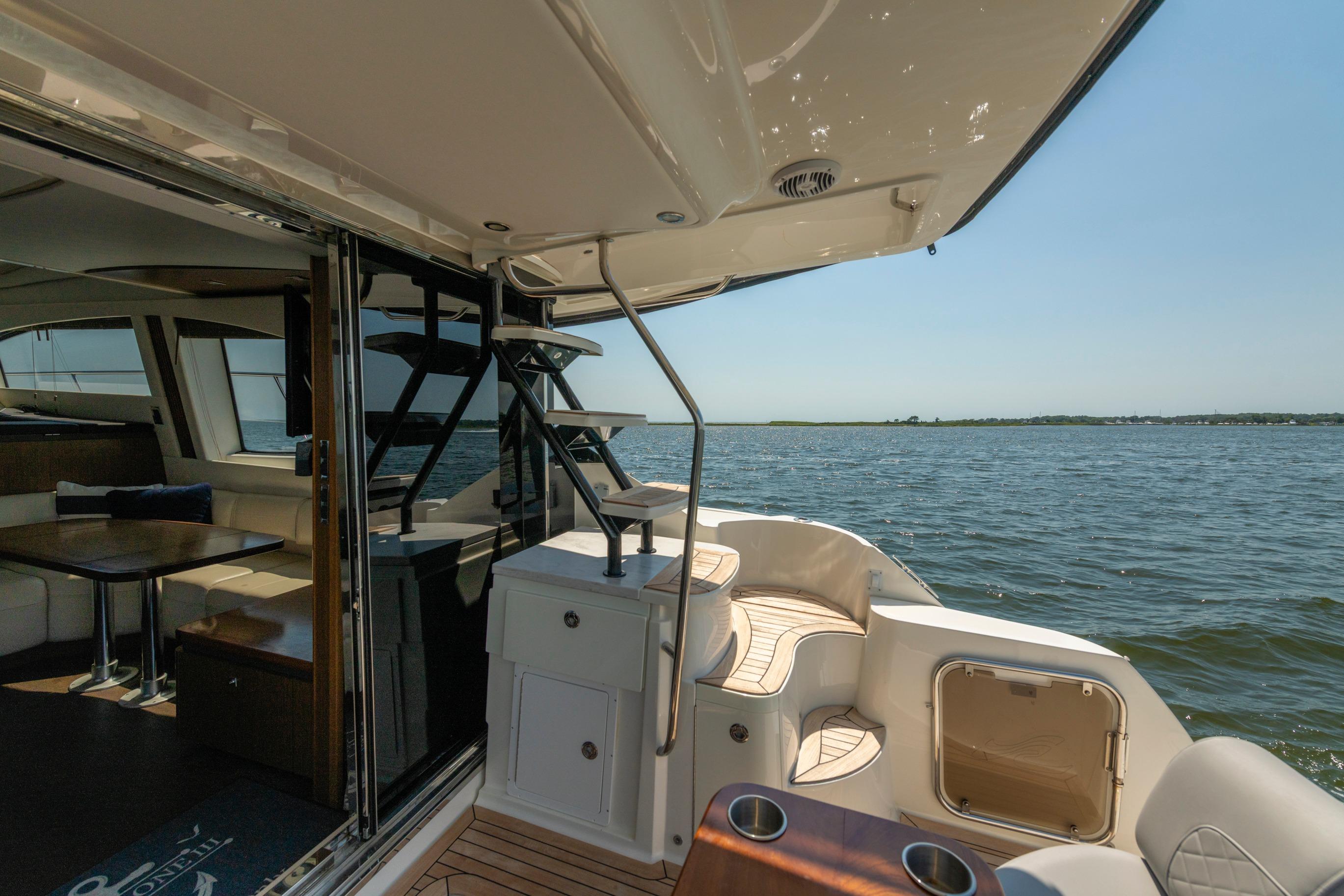 2017 Sea Ray Fly 510 yacht interior with ocean view, featuring elegant seating and modern design.
