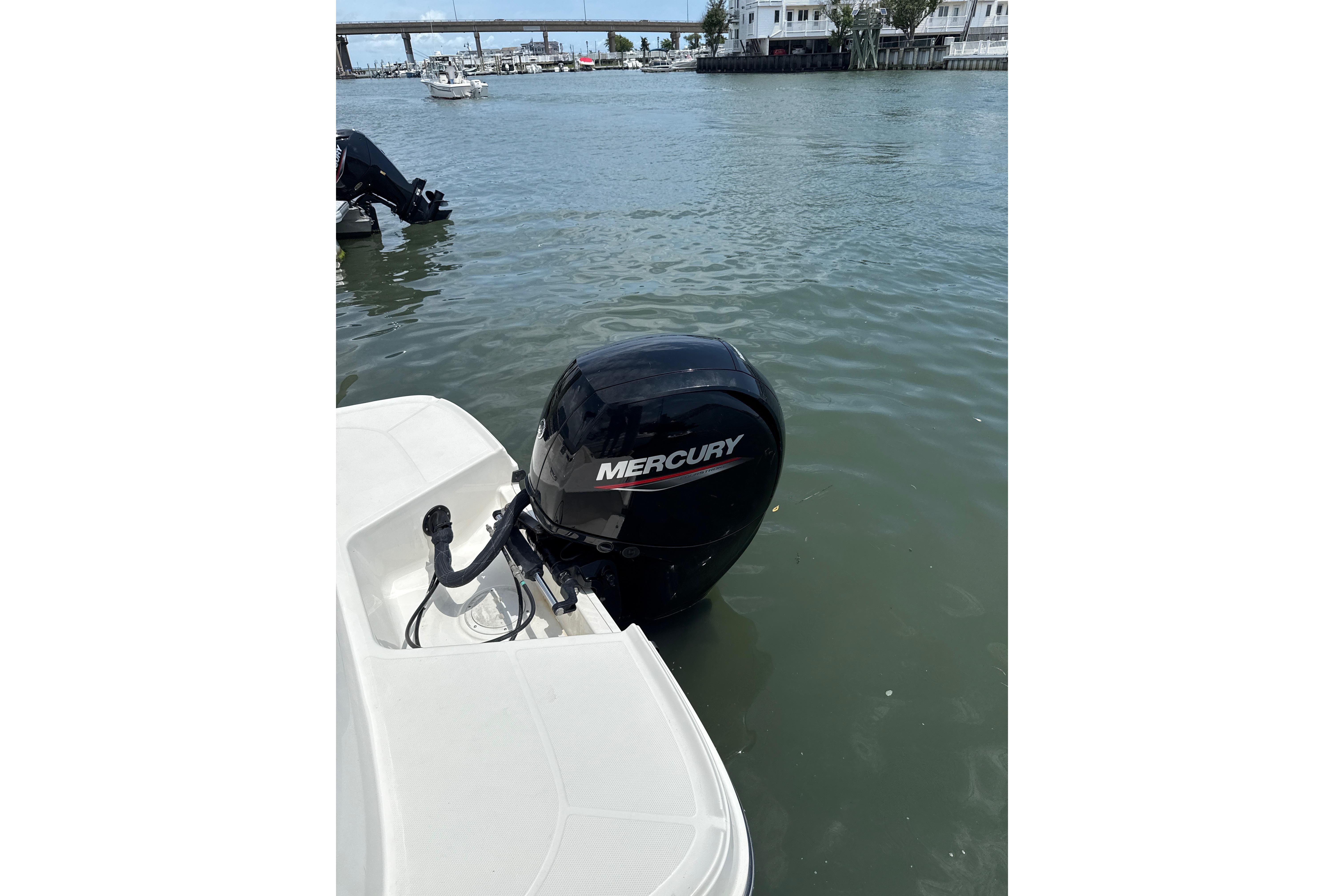 2023 Bayliner VR6 Bowrider OB with Mercury outboard motor on water.