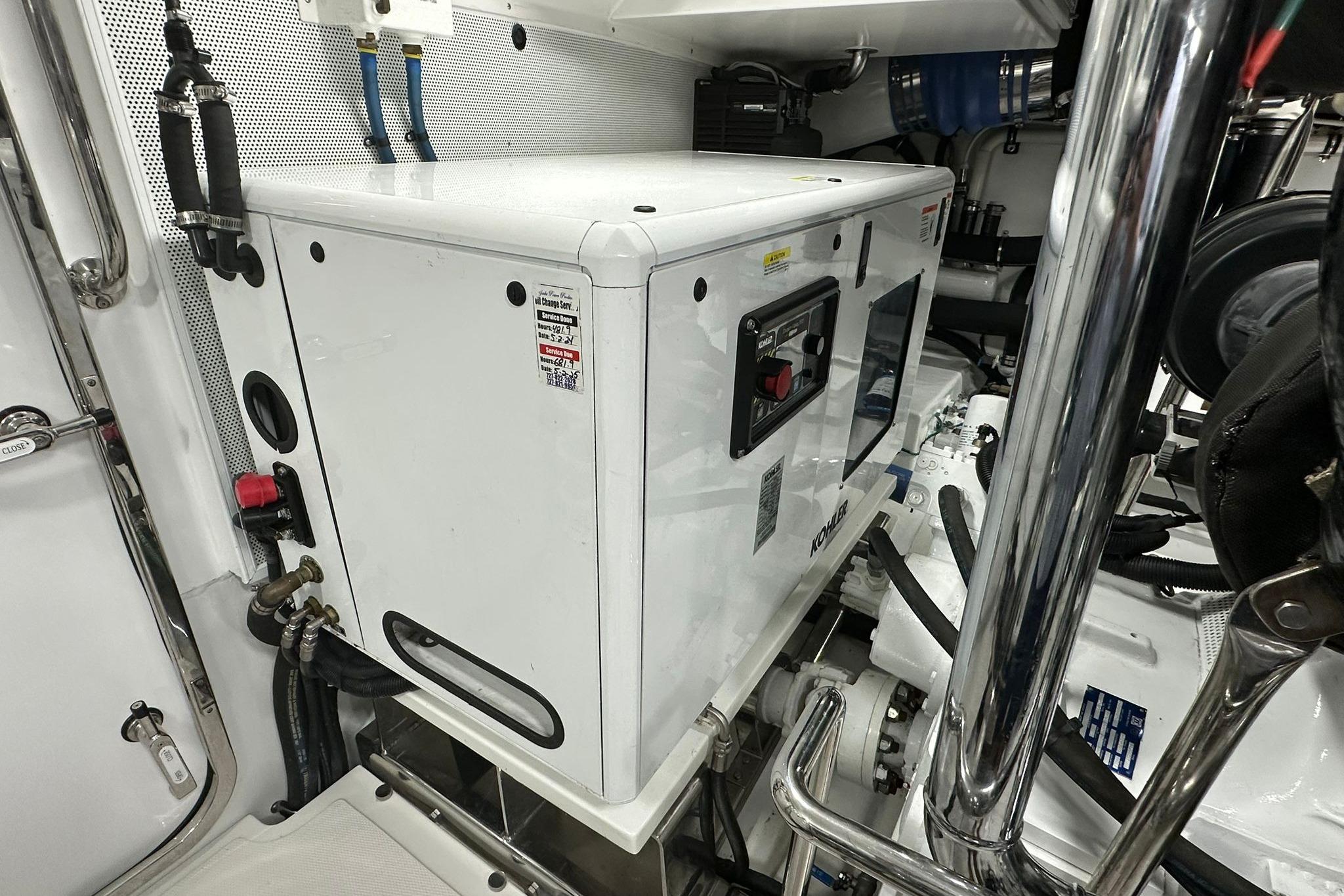 Engine room of 2023 Marlow Explorer 66E-CB yacht with generator and equipment.