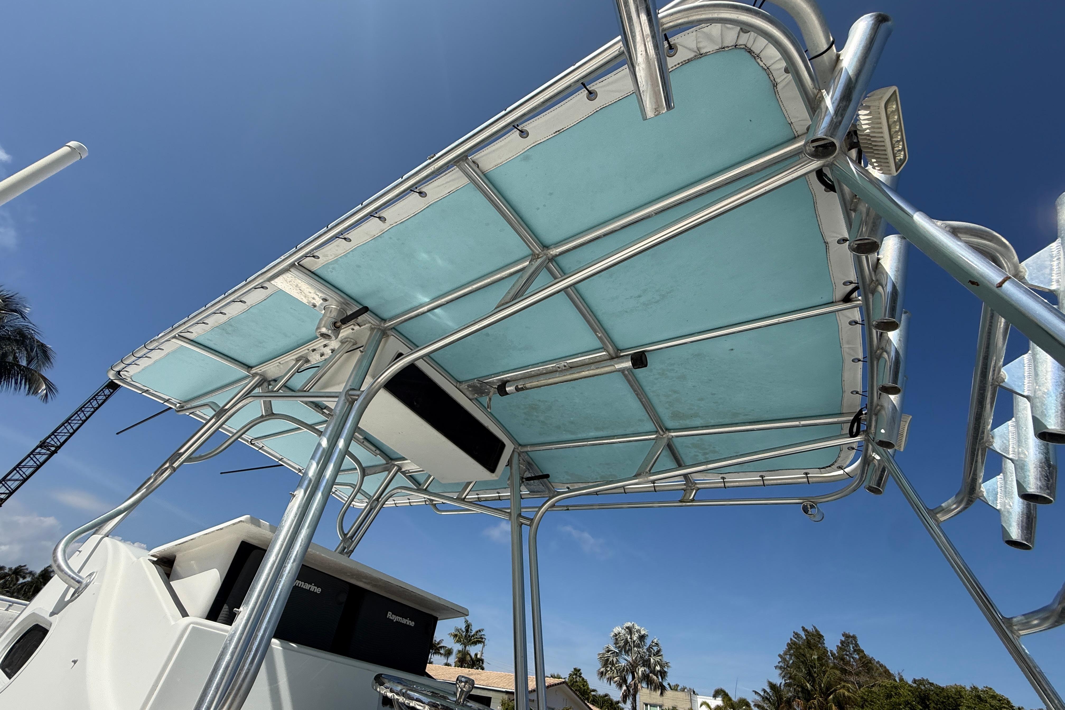 2003 Palmetto 33 Adventure boat with blue canopy and stainless steel frame.