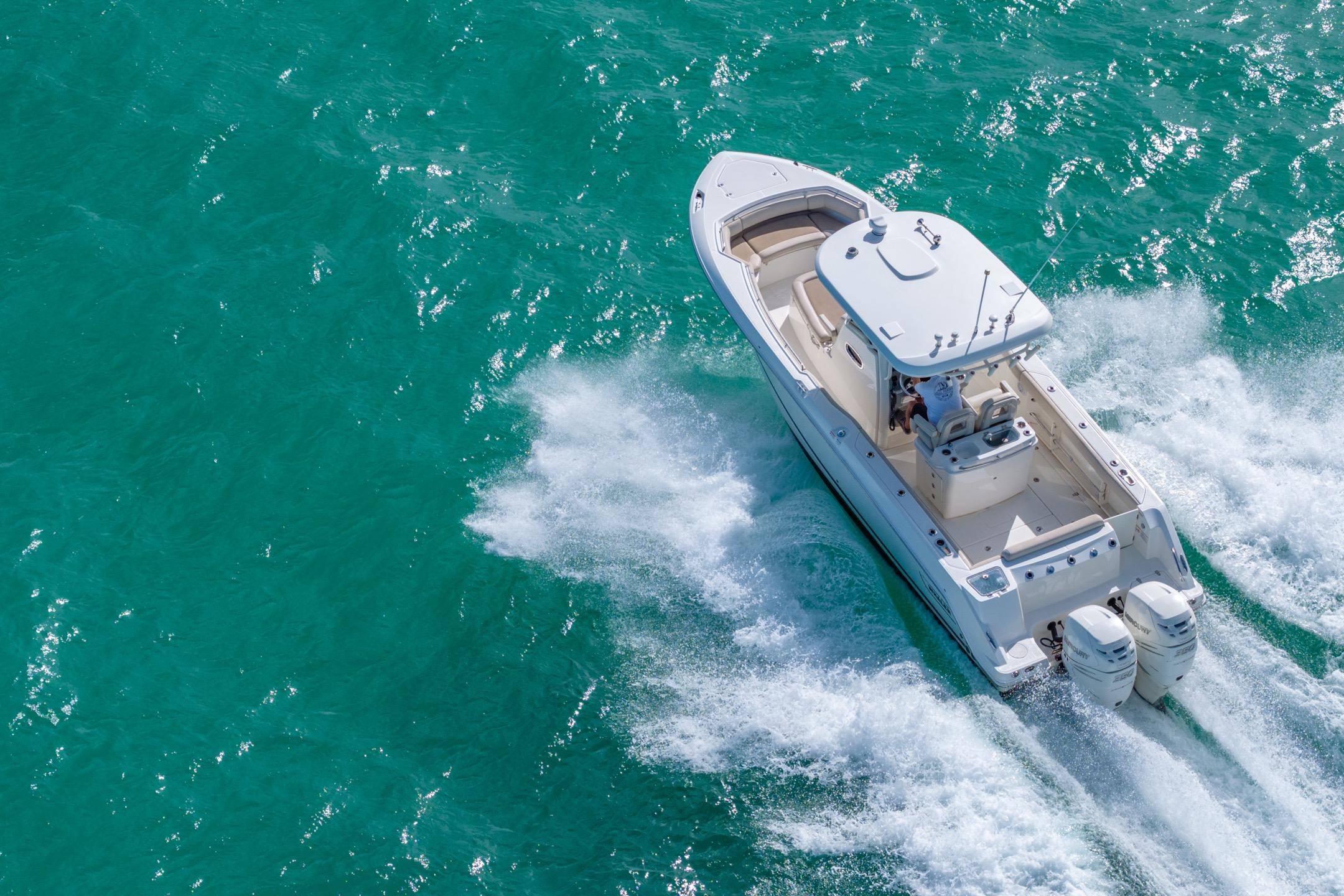 2016 Boston Whaler 280 Outrage cruising on turquoise waters, aerial view.