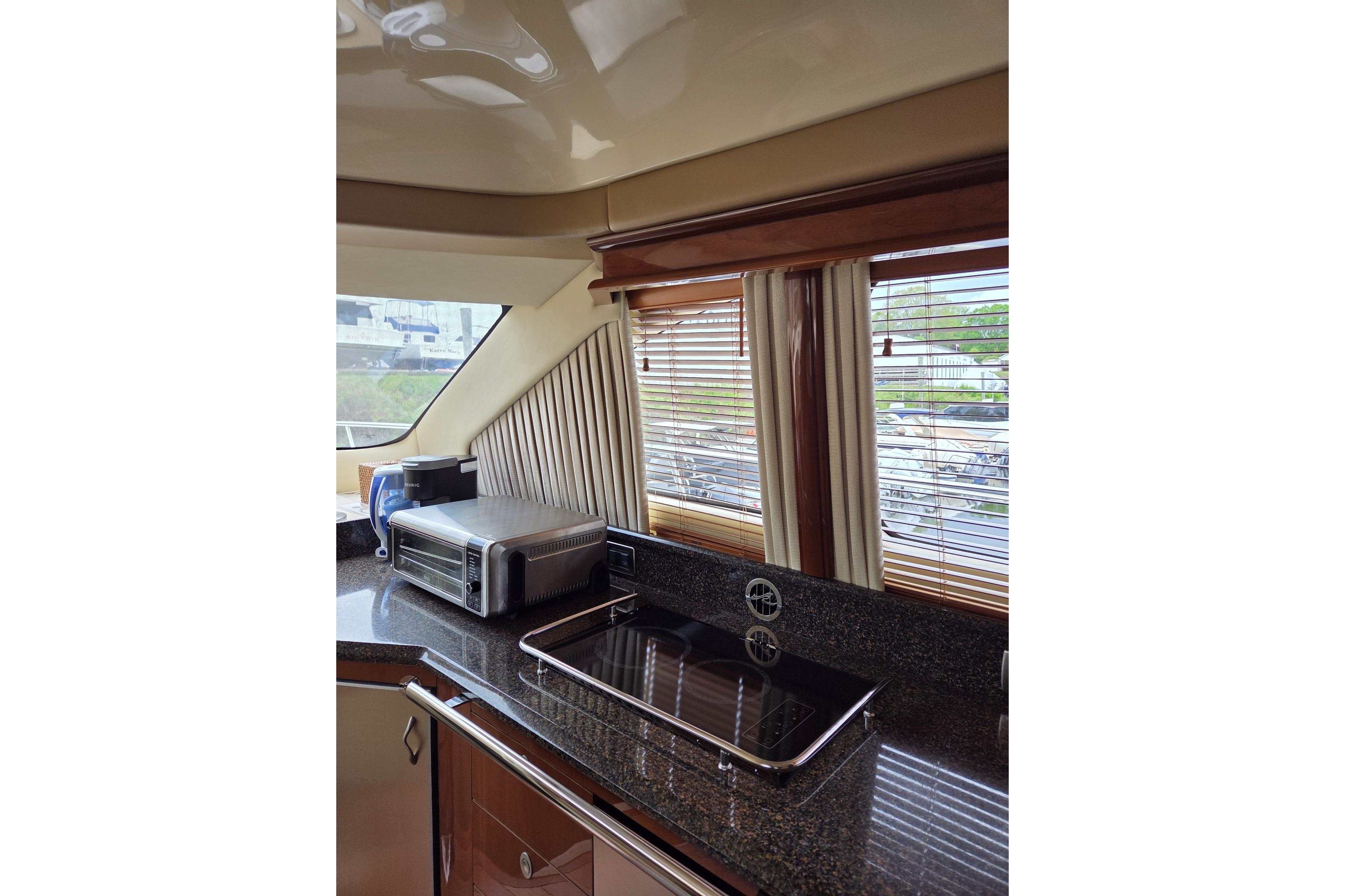 Luxurious kitchen interior of 2007 Sea Ray 580 Sedan Bridge yacht with modern appliances.