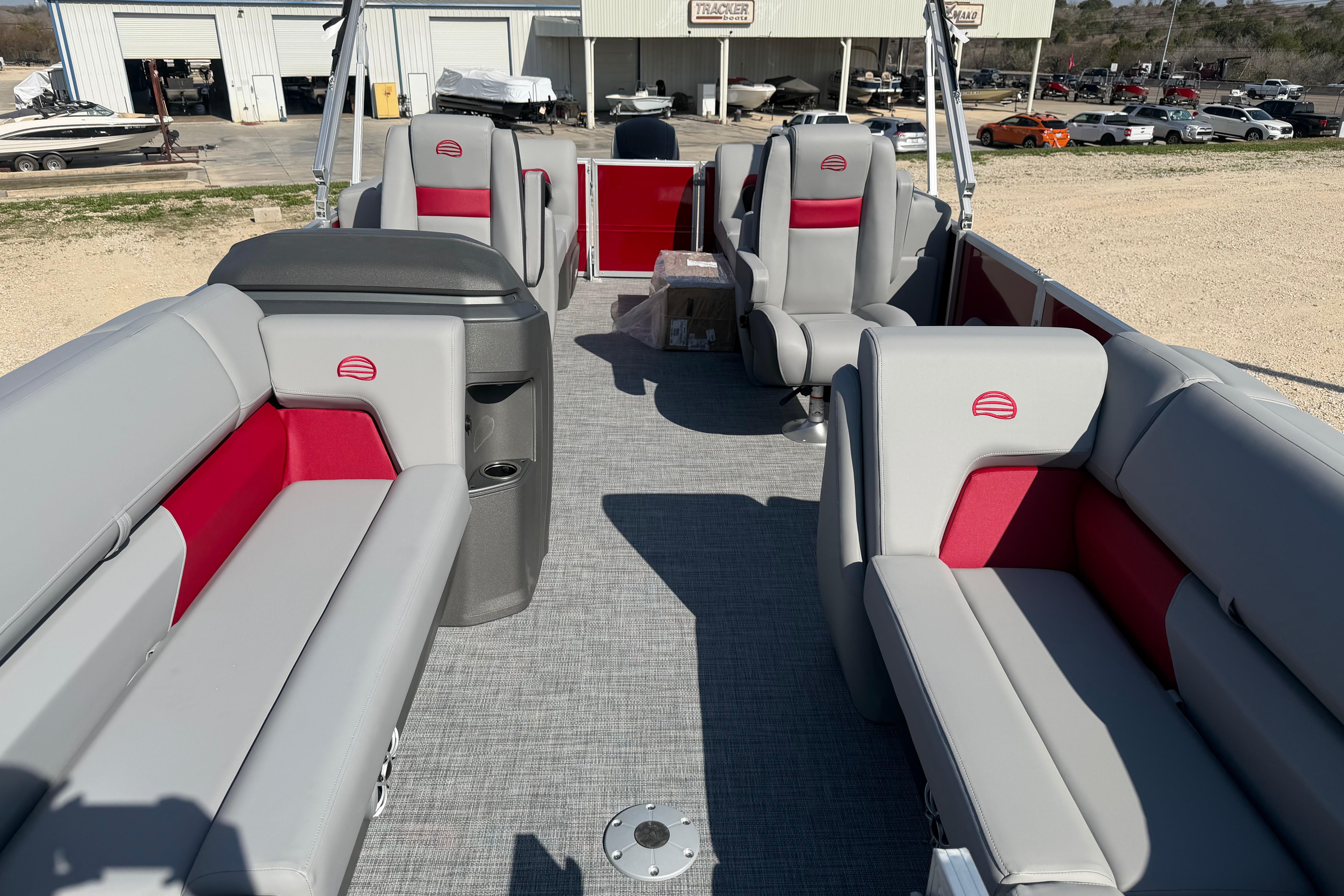 2026 Sun Tracker Party Barge 22 DLX interior with gray and red seating, spacious layout.