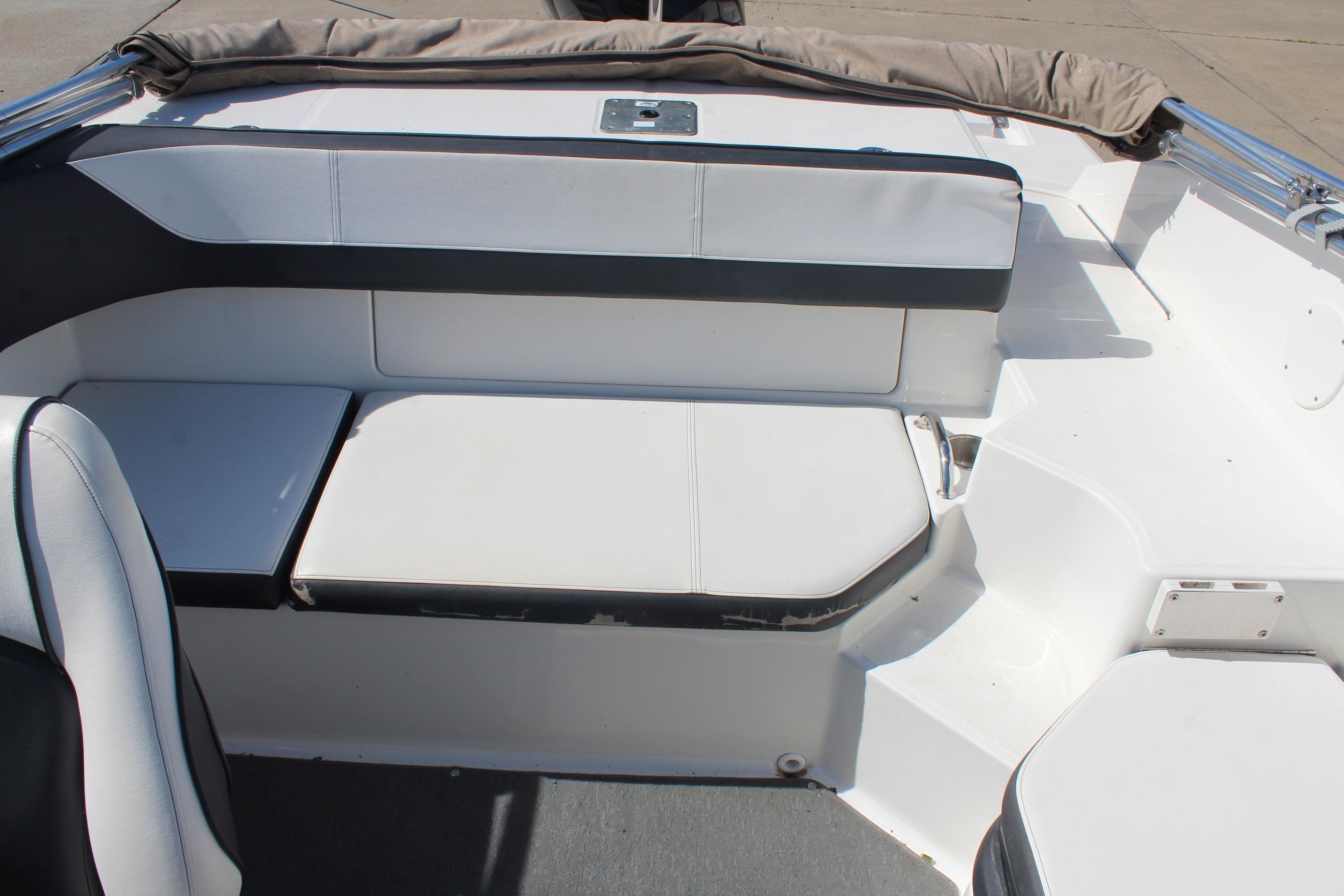 Interior seating of a 2015 Sea Ray 19 SPX OB boat, featuring white upholstery.