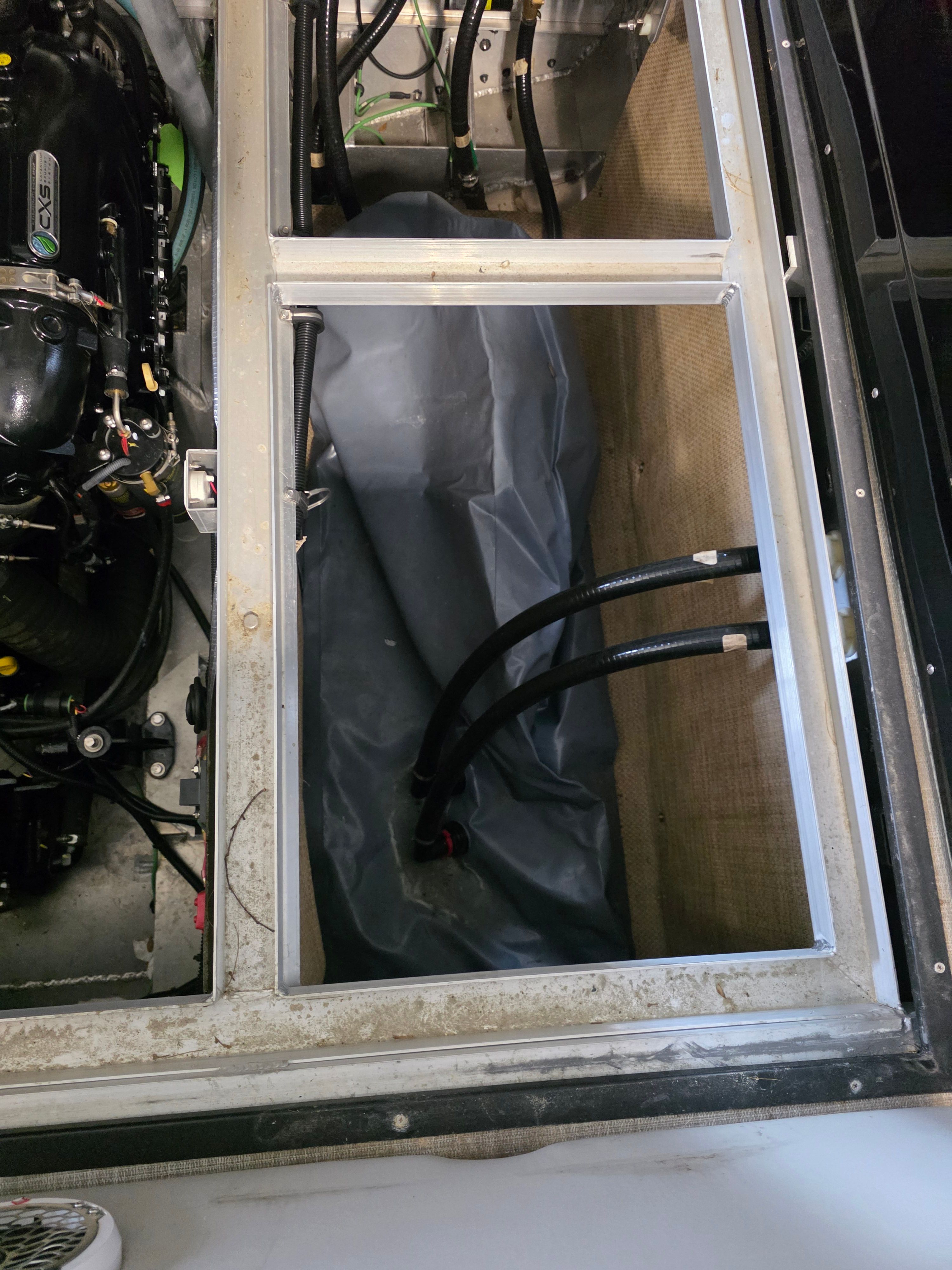 Engine compartment of 2021 Montara SURF BOSS 25 with hoses and engine.