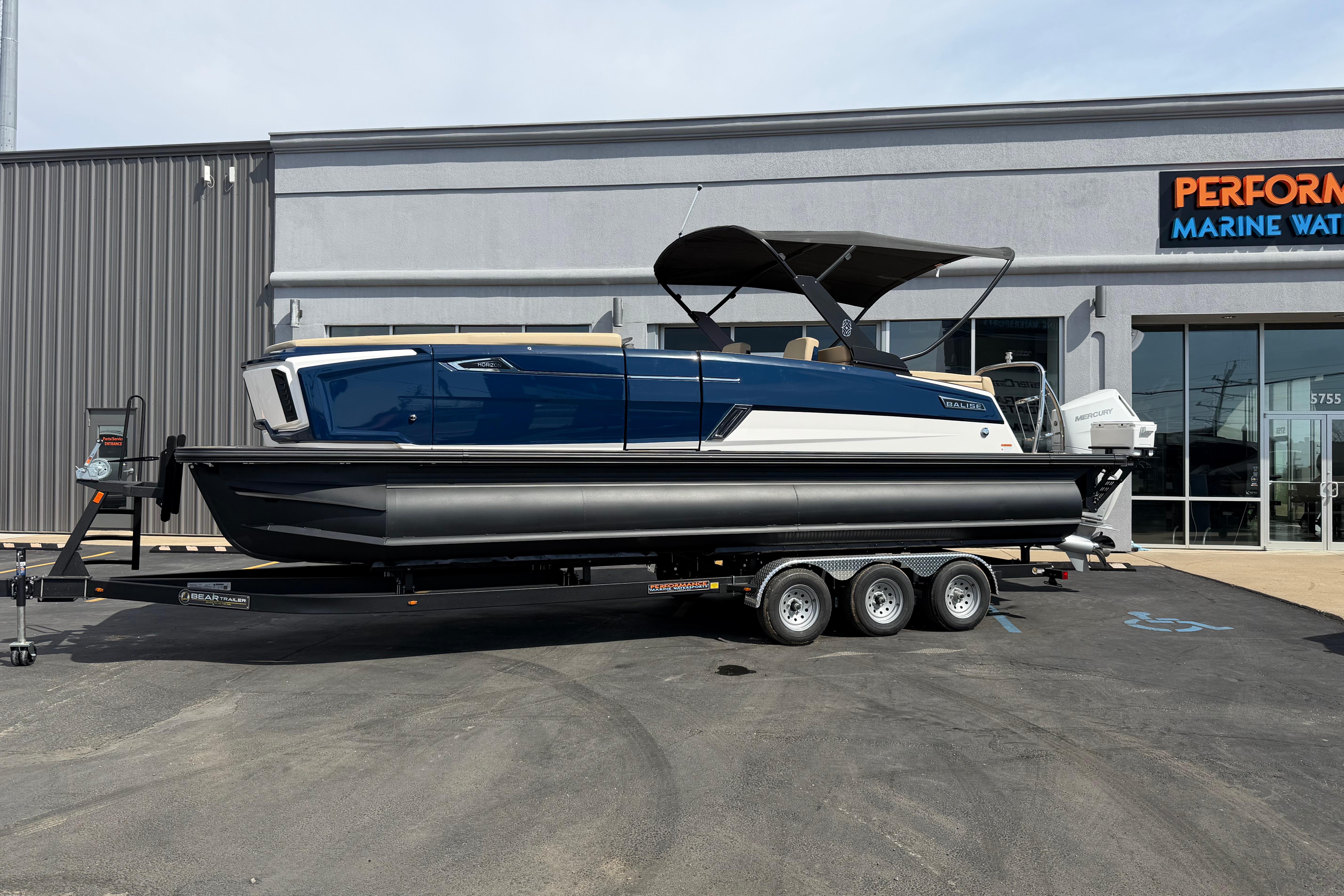2025 Balise HORIZON26C boat on trailer outside marine dealership.