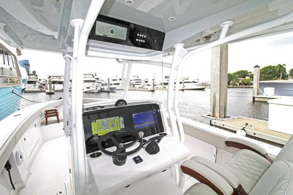 2024 Jupiter 34 HFS boat cockpit with advanced navigation system at marina.