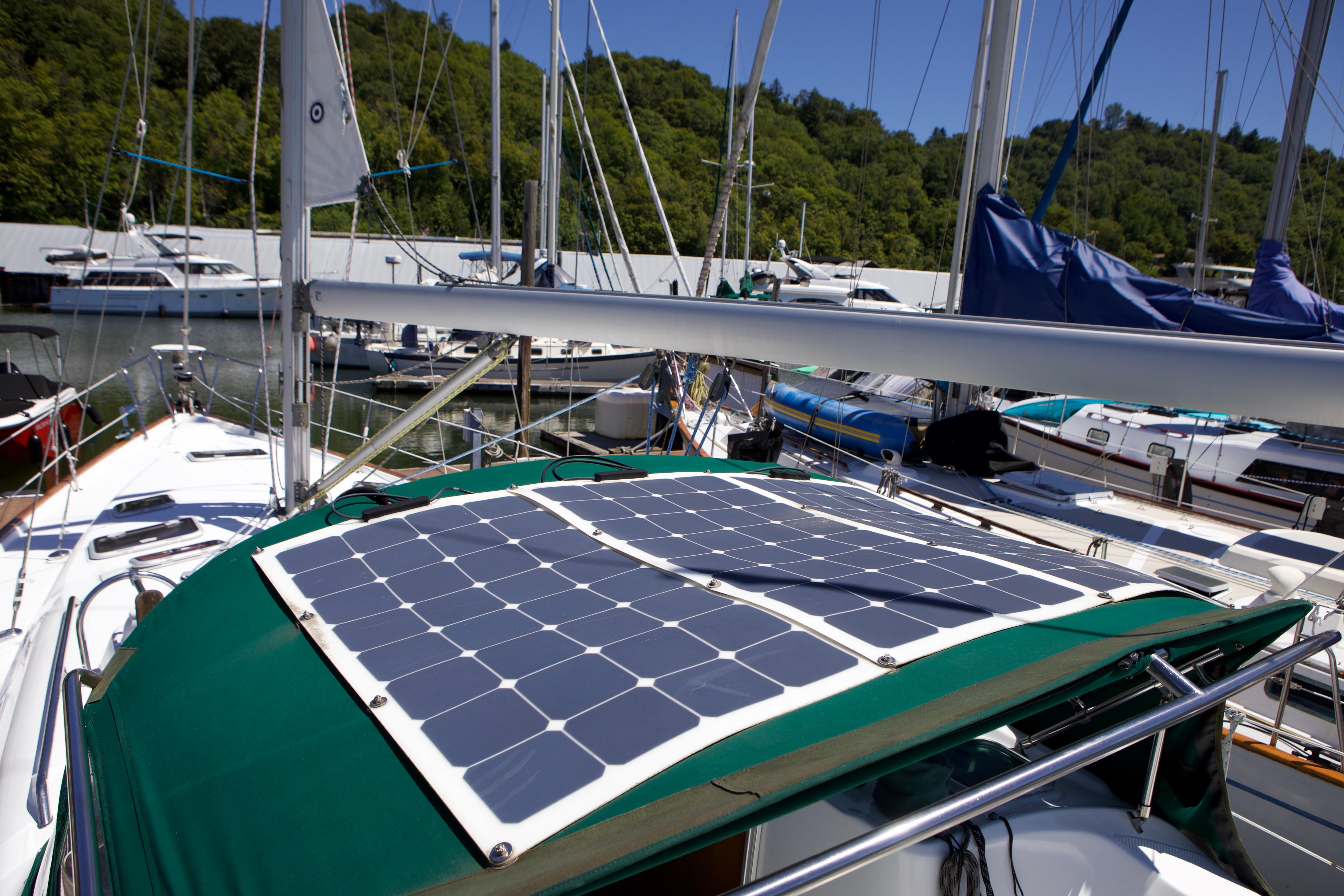 2005 Beneteau 423 sailboat with solar panels docked in a marina.