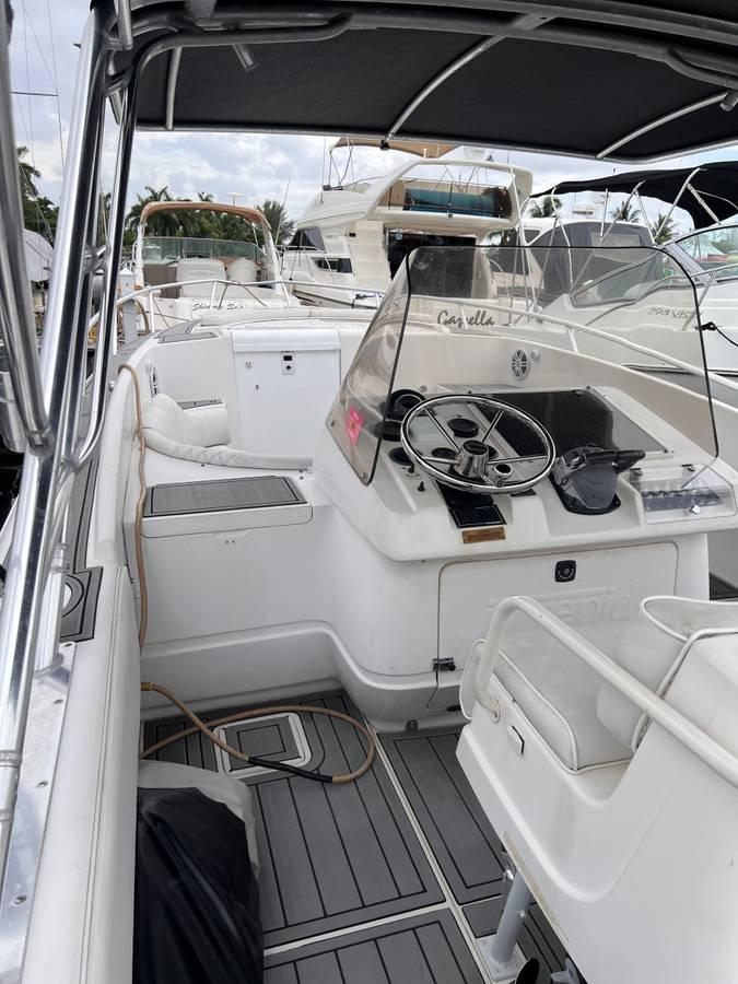 1996 Intrepid 370 Cuddy boat interior with steering wheel and seating area.