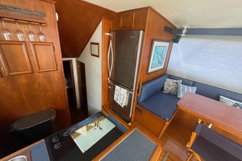 Interior of 1987 Topaz 44 Flybridge yacht with kitchen and seating area.