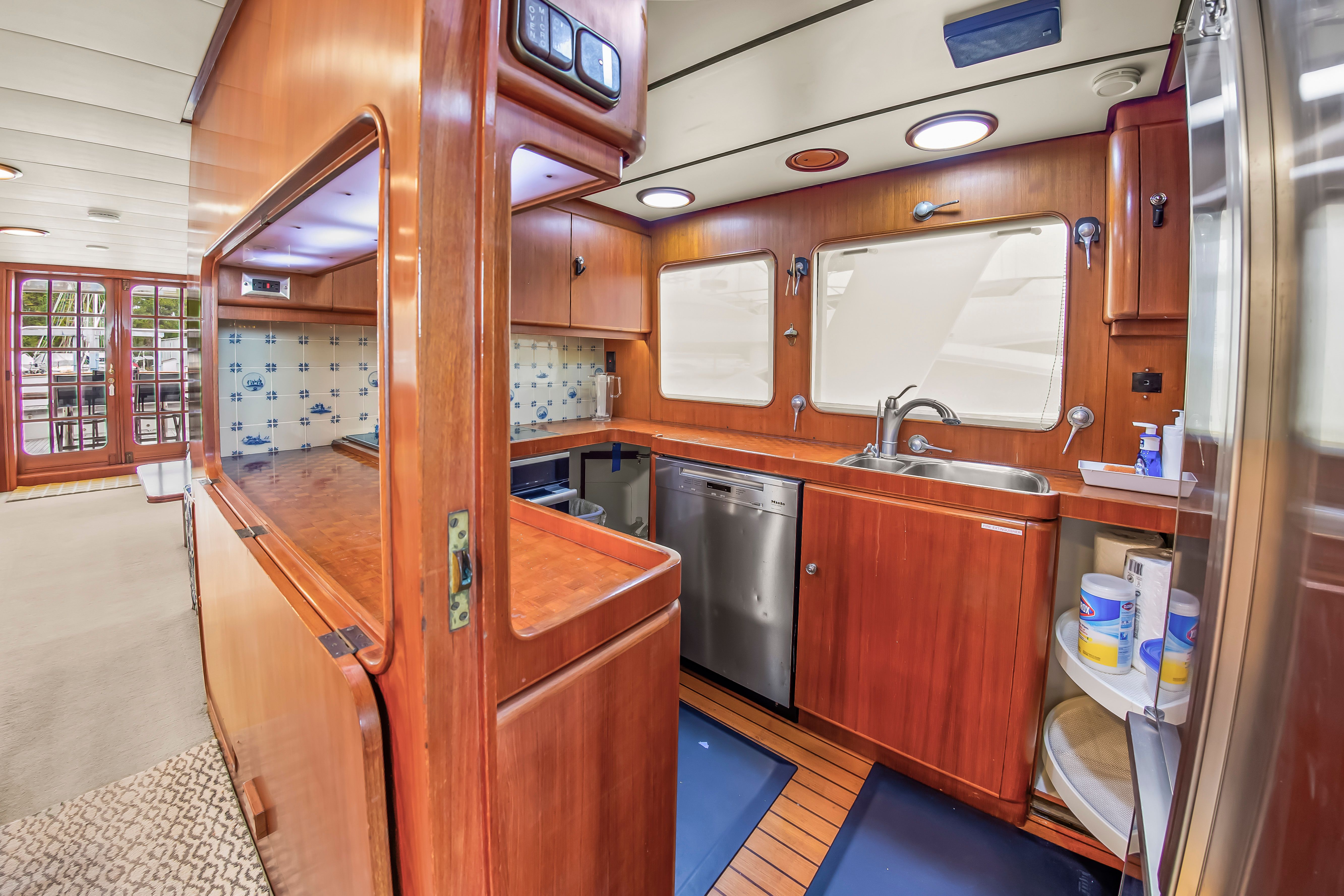 Interior of a 1987 Jongert 78 Motor Yacht with wooden cabinetry and modern kitchen.