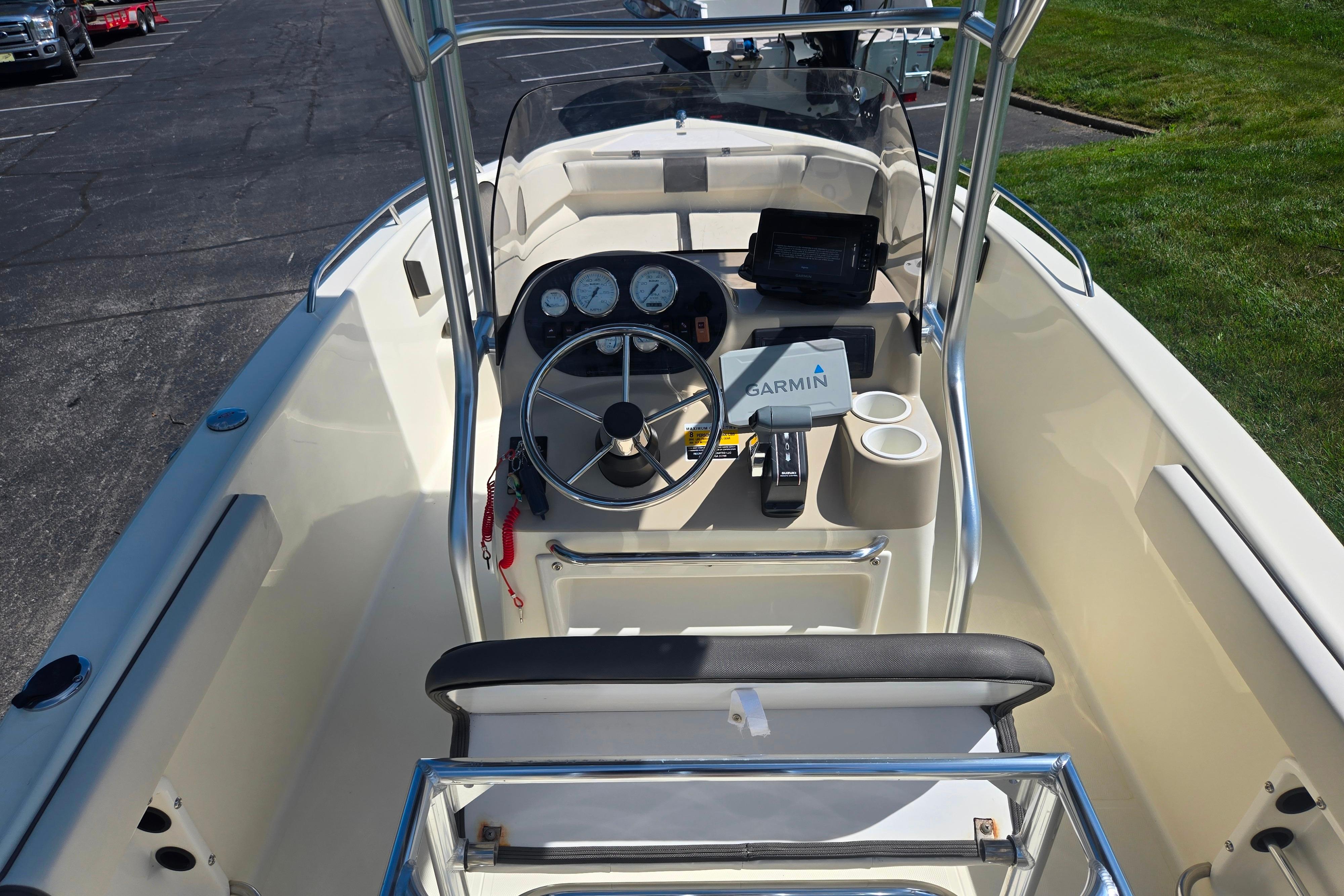 2016 Key Largo 2000CC boat cockpit with steering wheel and Garmin navigation system.