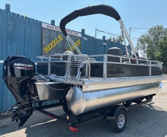 2026 Sun Tracker Bass Buggy 18 DLX pontoon boat with Mercury engine, parked outdoors.