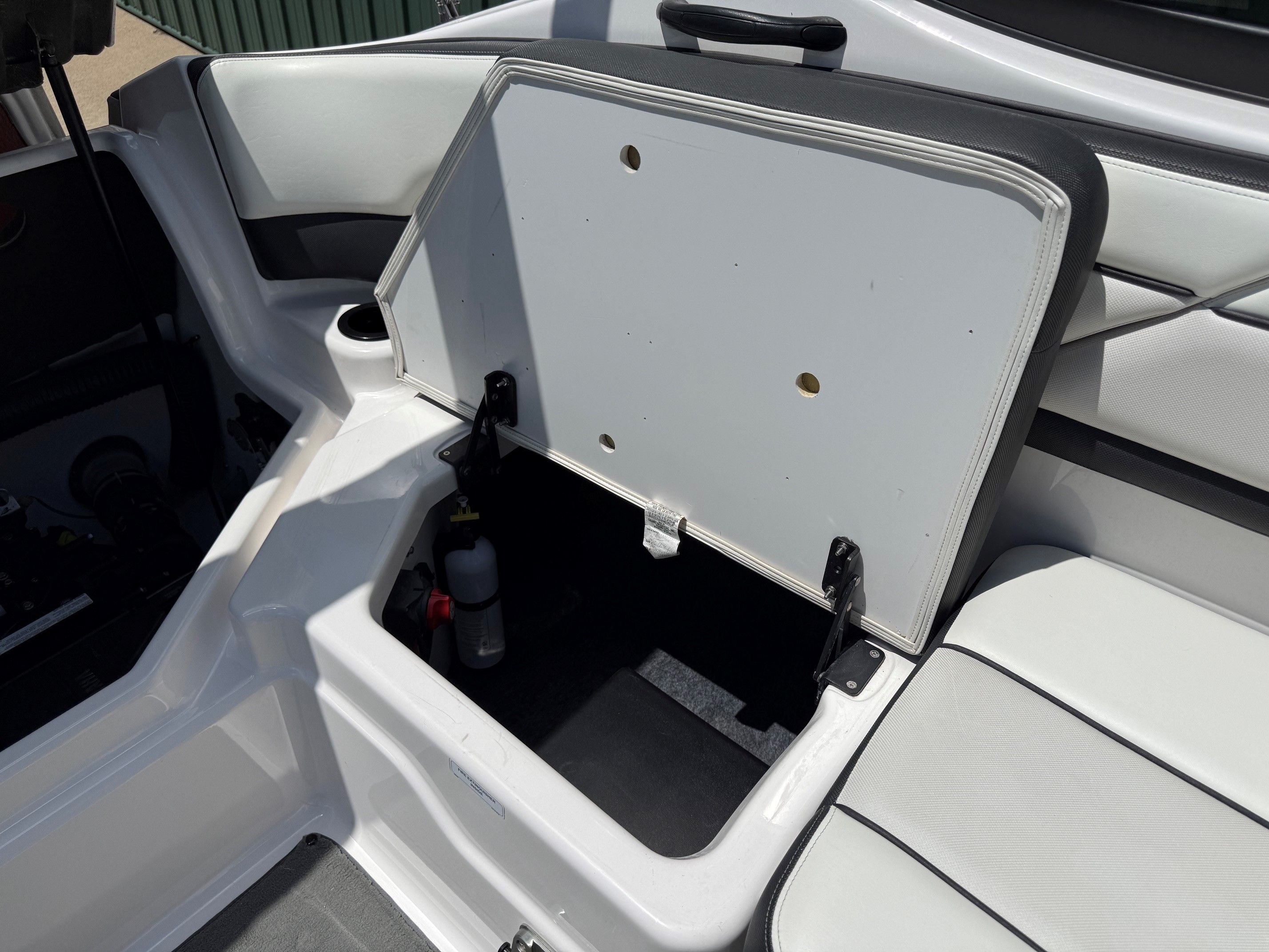 Open storage compartment on a Yamaha SX210 boat.