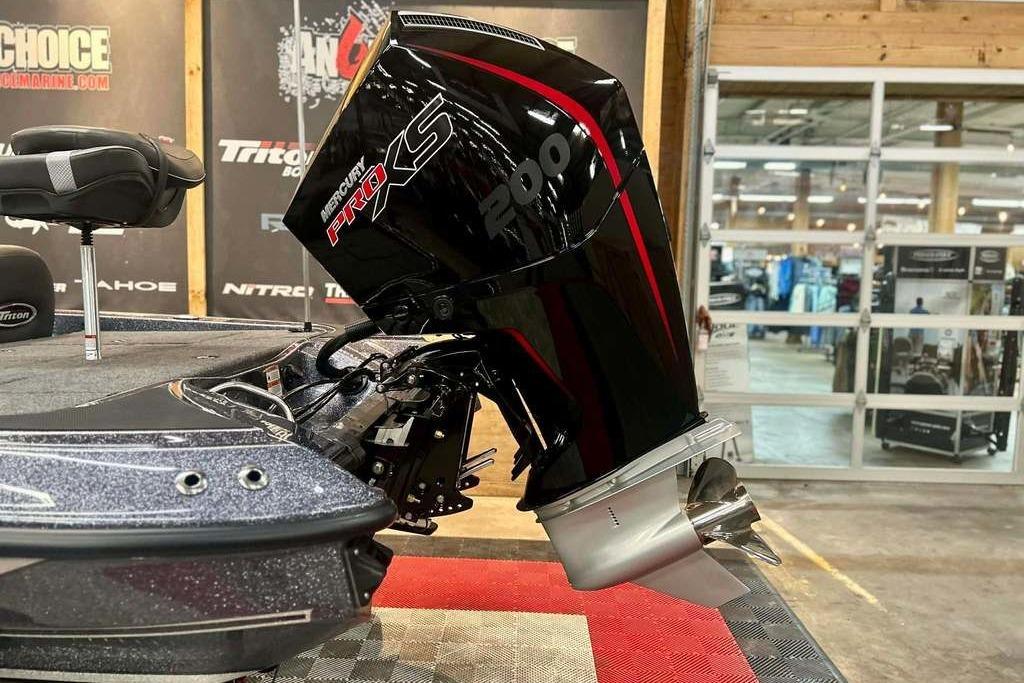 2026 Triton 18 TrX boat with Mercury Pro XS 200 engine in showroom.