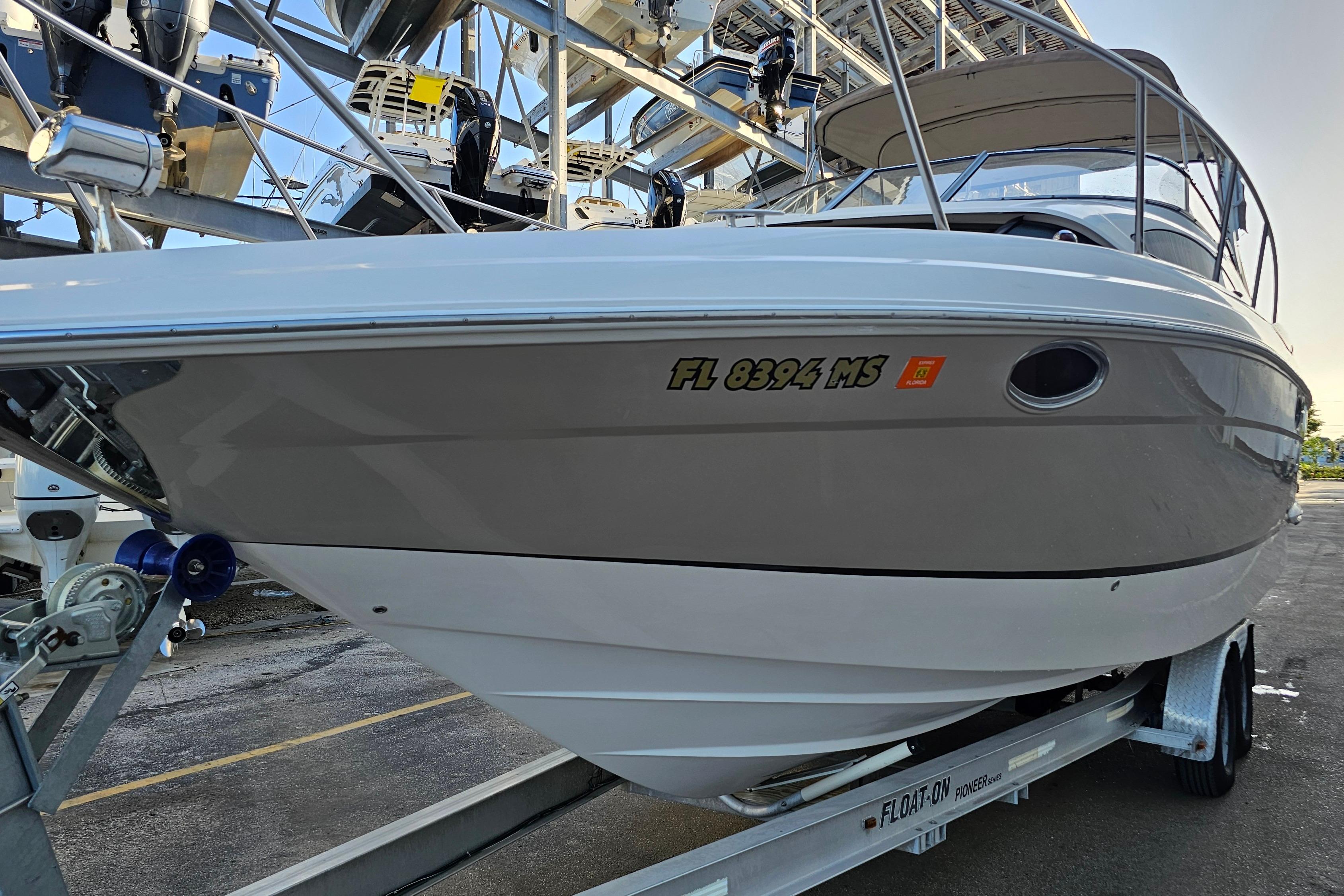 2005 Regal 3060 Window Express boat on trailer, docked in marina.