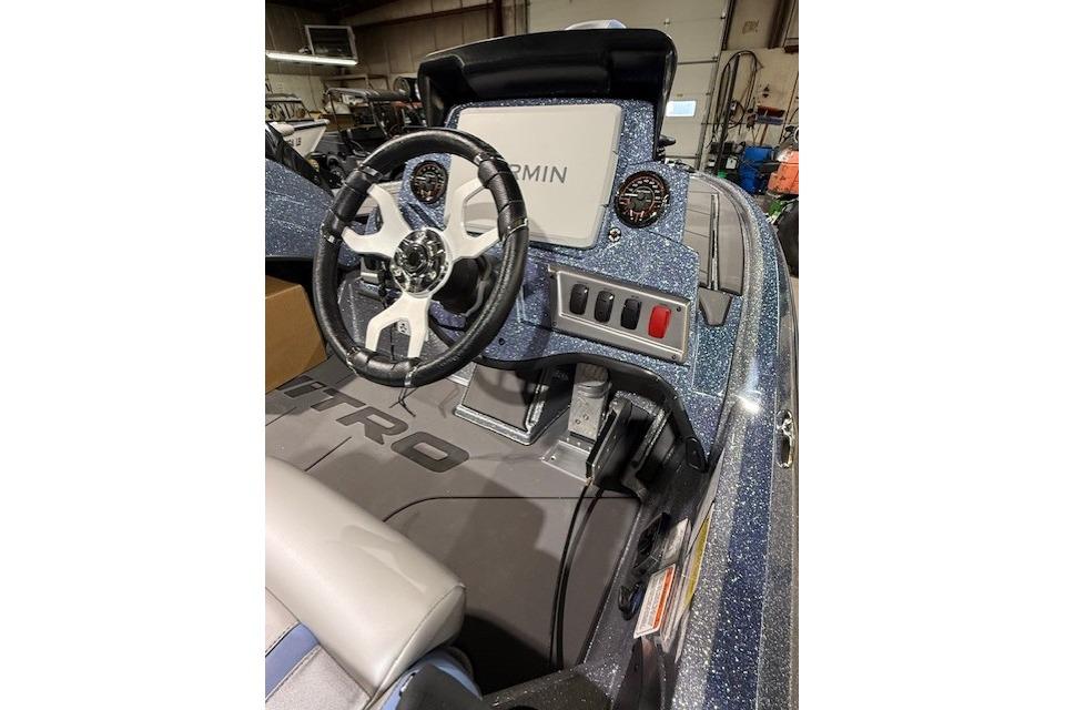 2026 Nitro Z19 XL Pro boat dashboard with steering wheel and Garmin display.