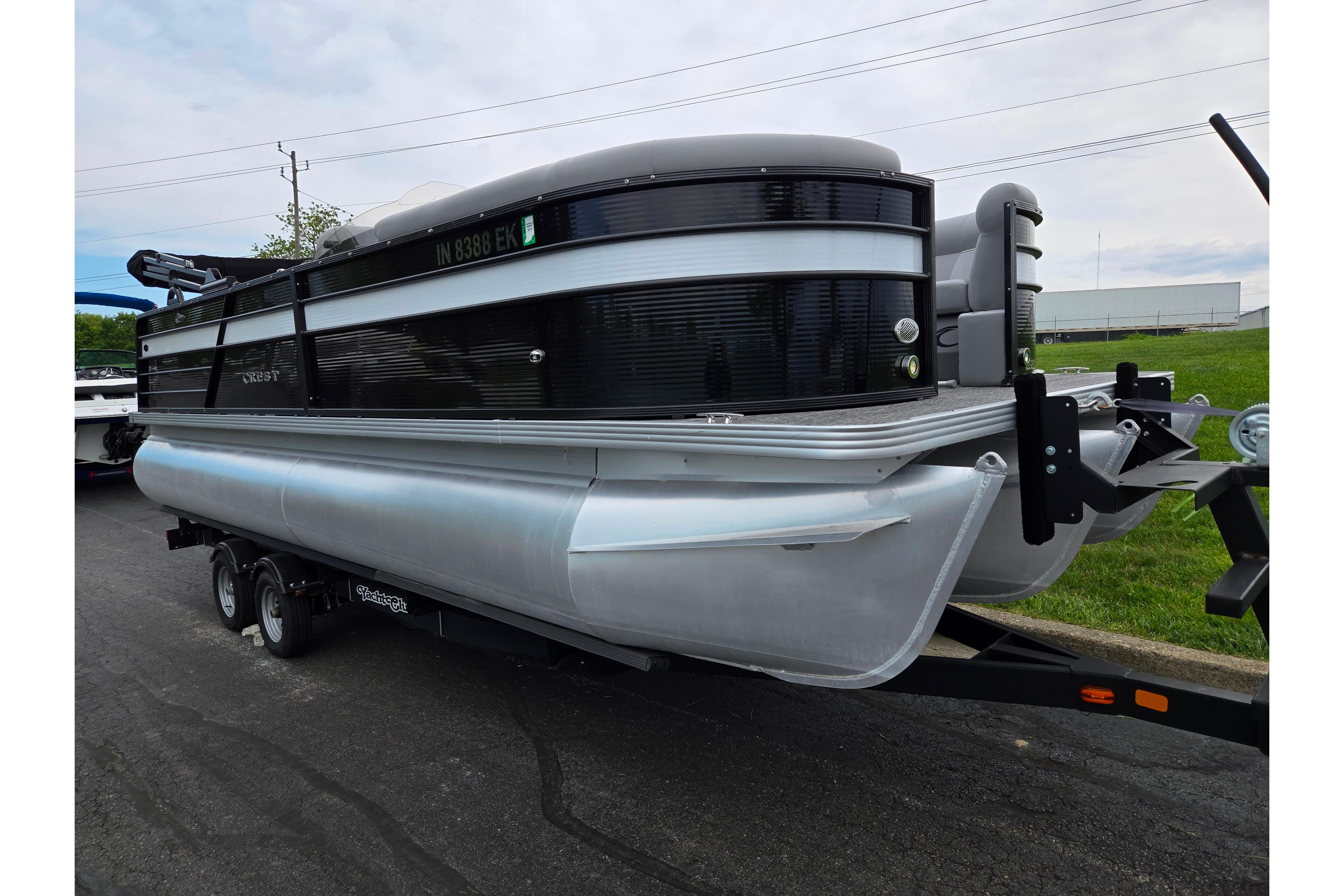 2022 Crest Classic DLX 220 pontoon boat on trailer, parked outdoors.