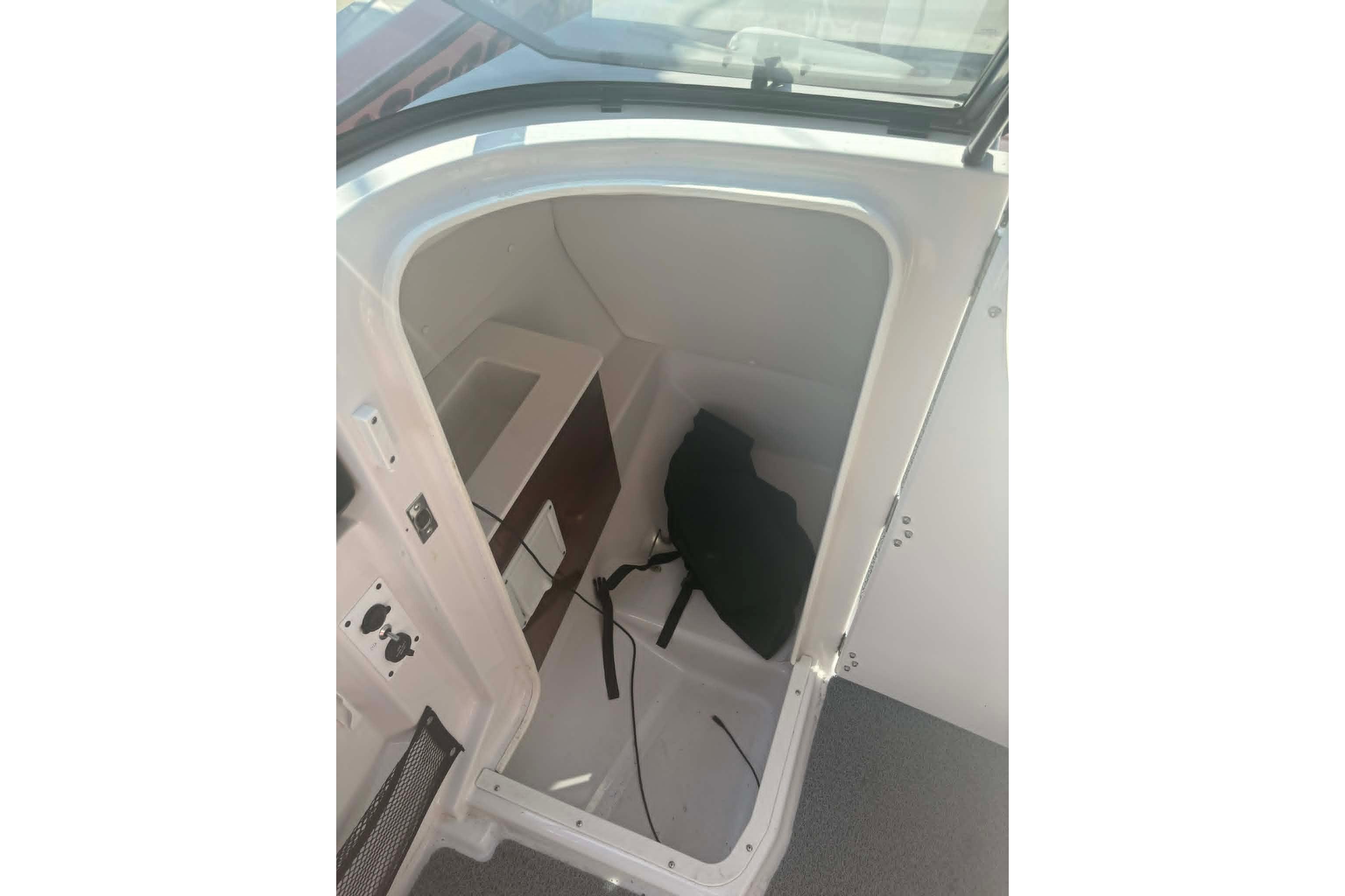 Interior cabin of 2016 Scarab 255 H.O. Impulse boat, featuring storage space.