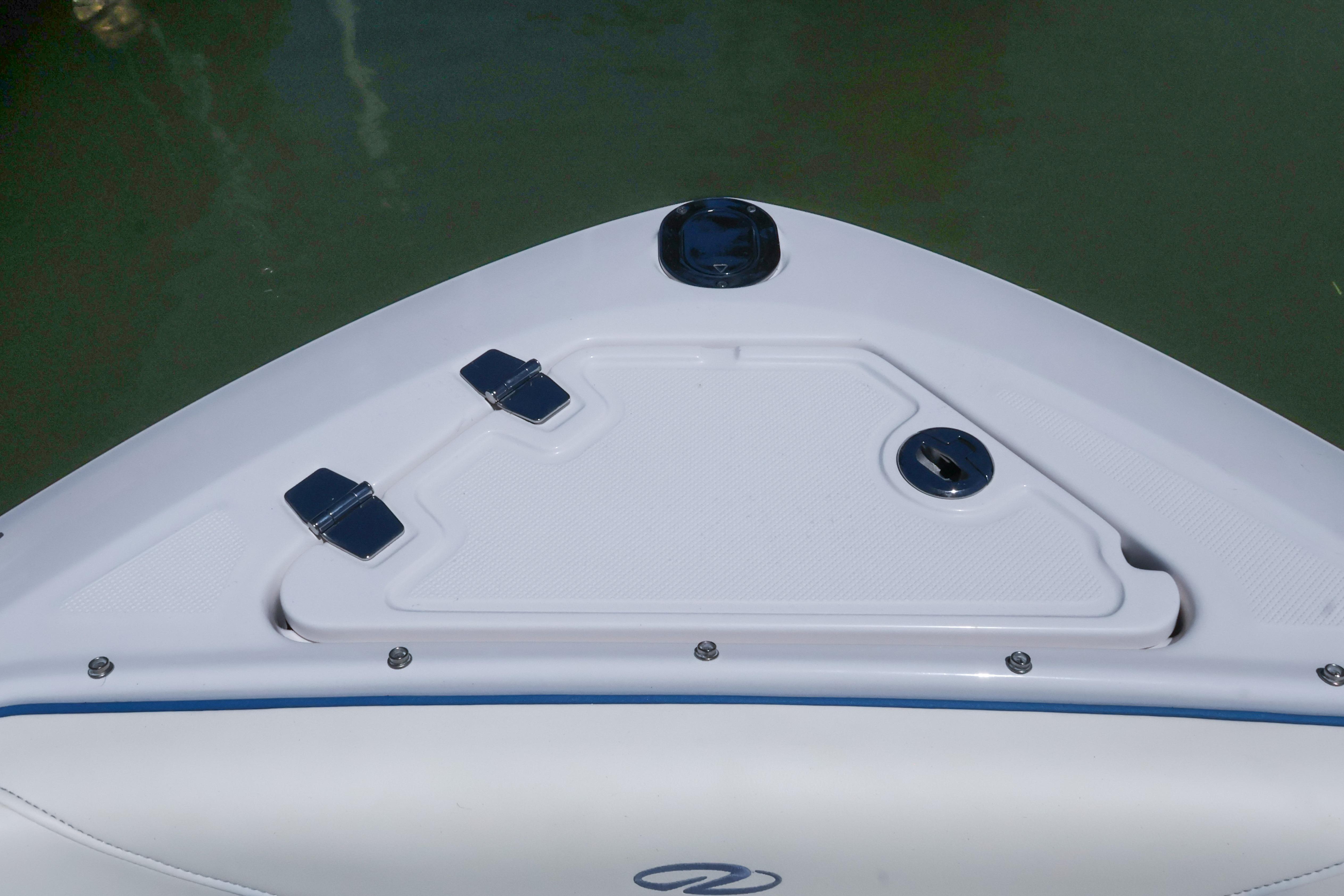 Bow of 2020 Regal LX4 boat with storage compartment and hinges.