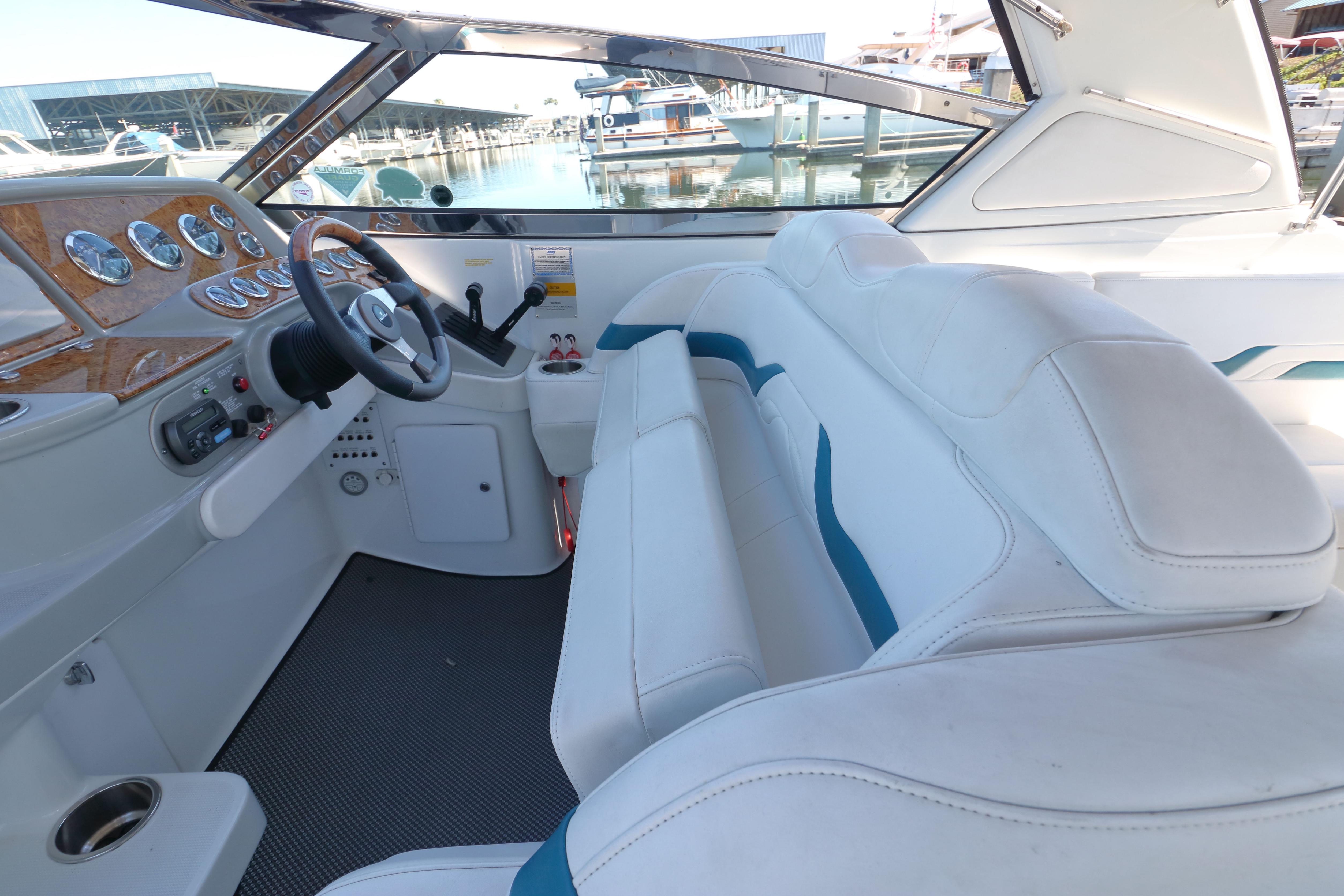 2006 Formula 330 Sun Sport boat interior with white seating and sleek dashboard design.