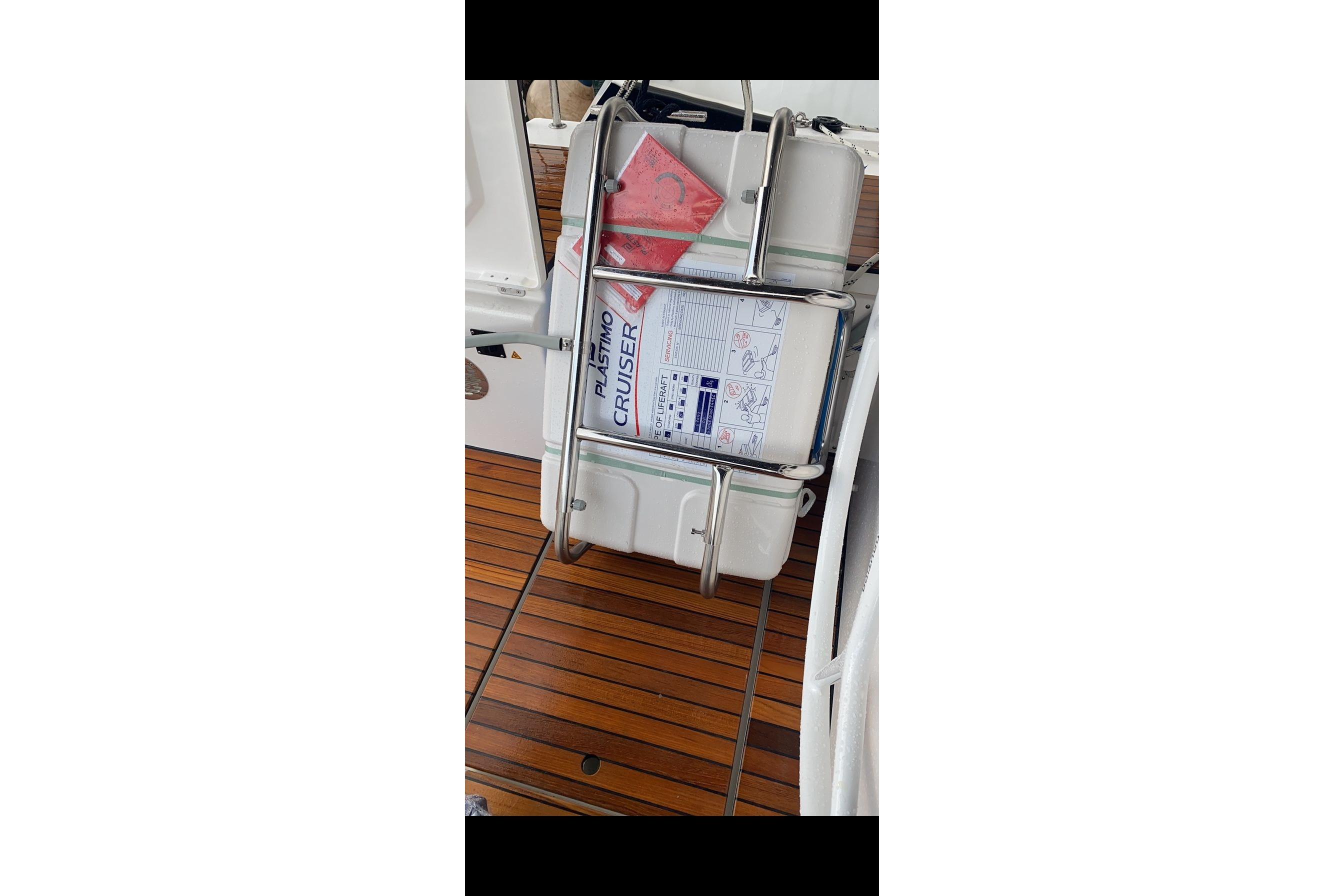 2022 Bavaria C50 Style yacht deck with safety equipment and wooden flooring.