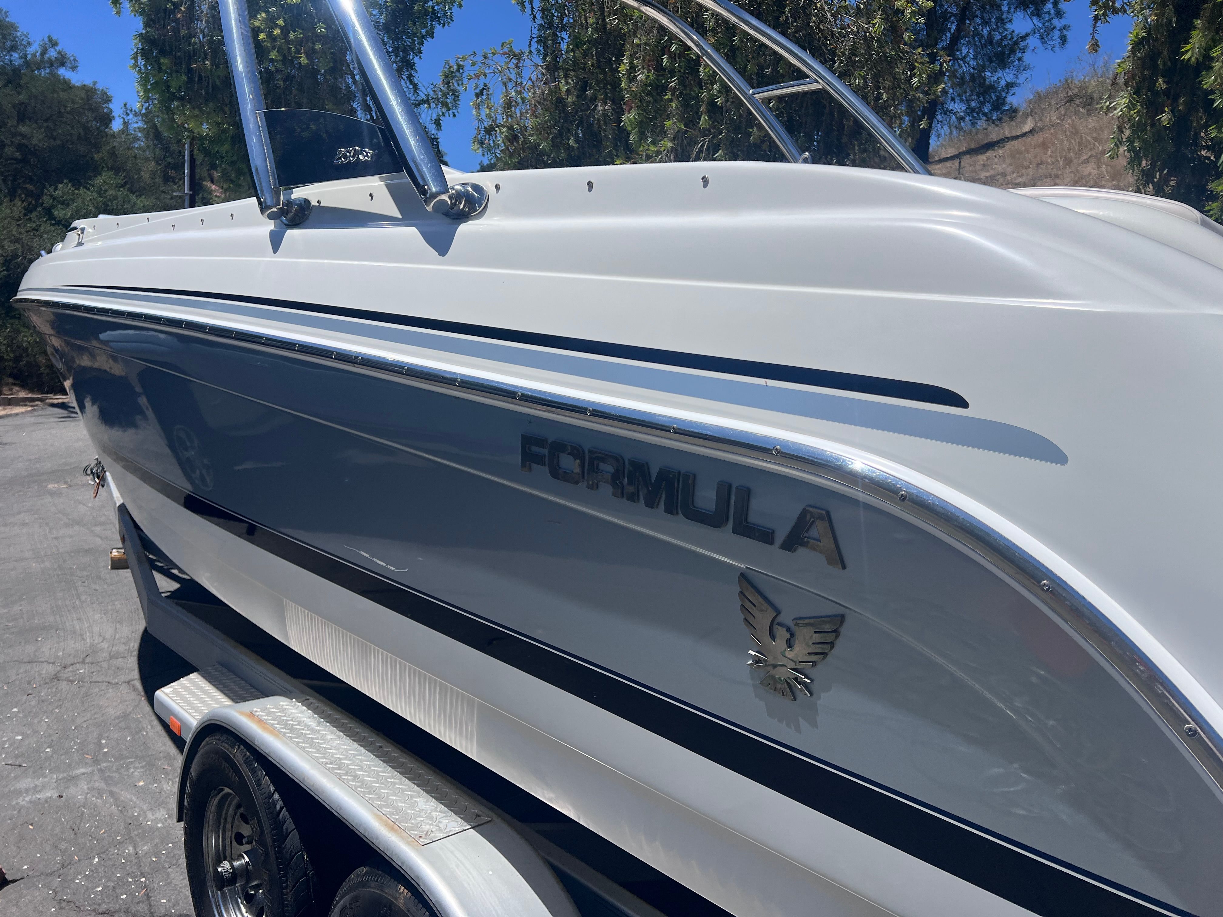2006 Formula 260 Sun Sport boat on trailer, side view.
