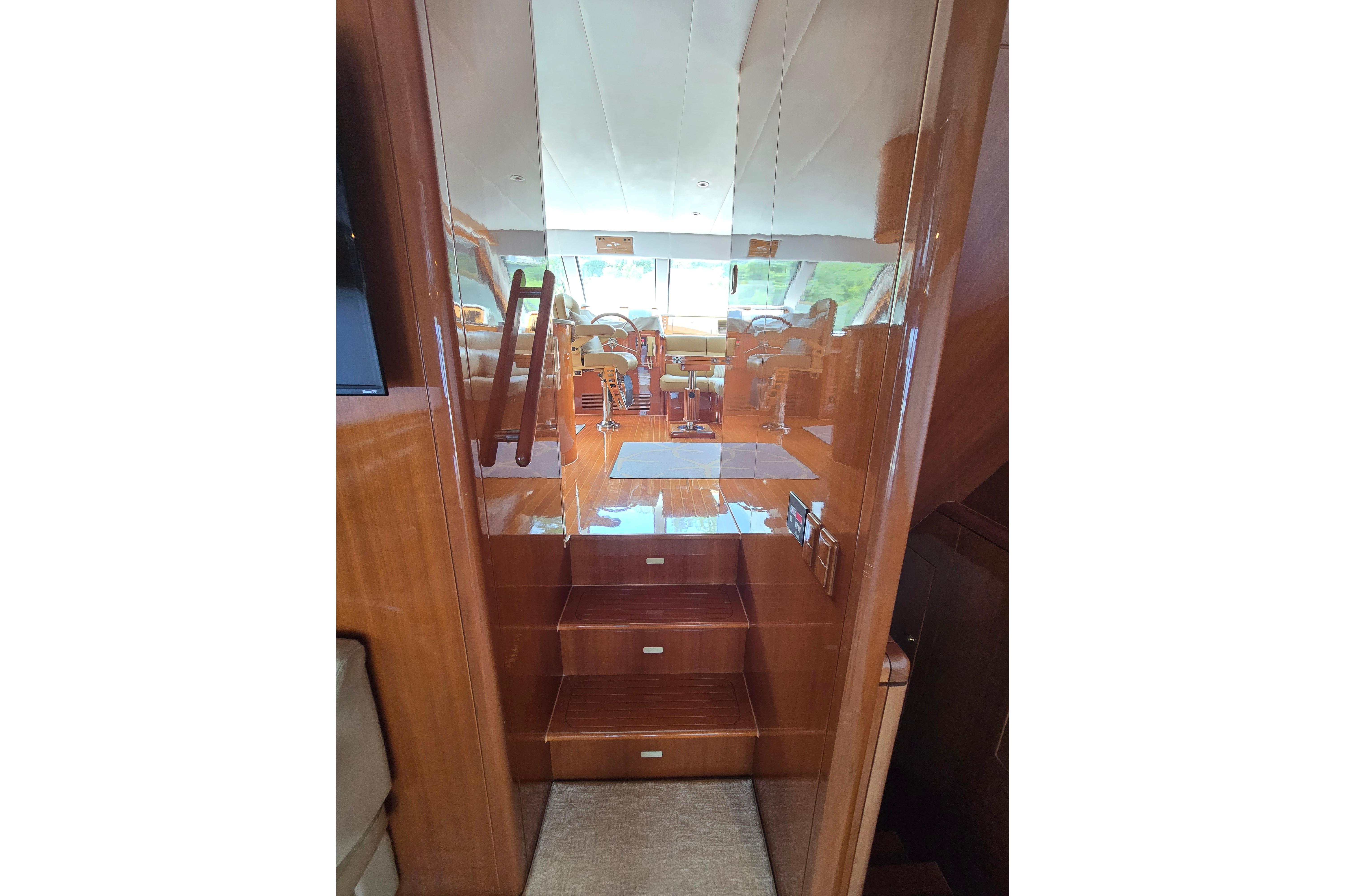Interior view of 2004 Grand Harbour 58 yacht, featuring polished wooden stairs and elegant design.