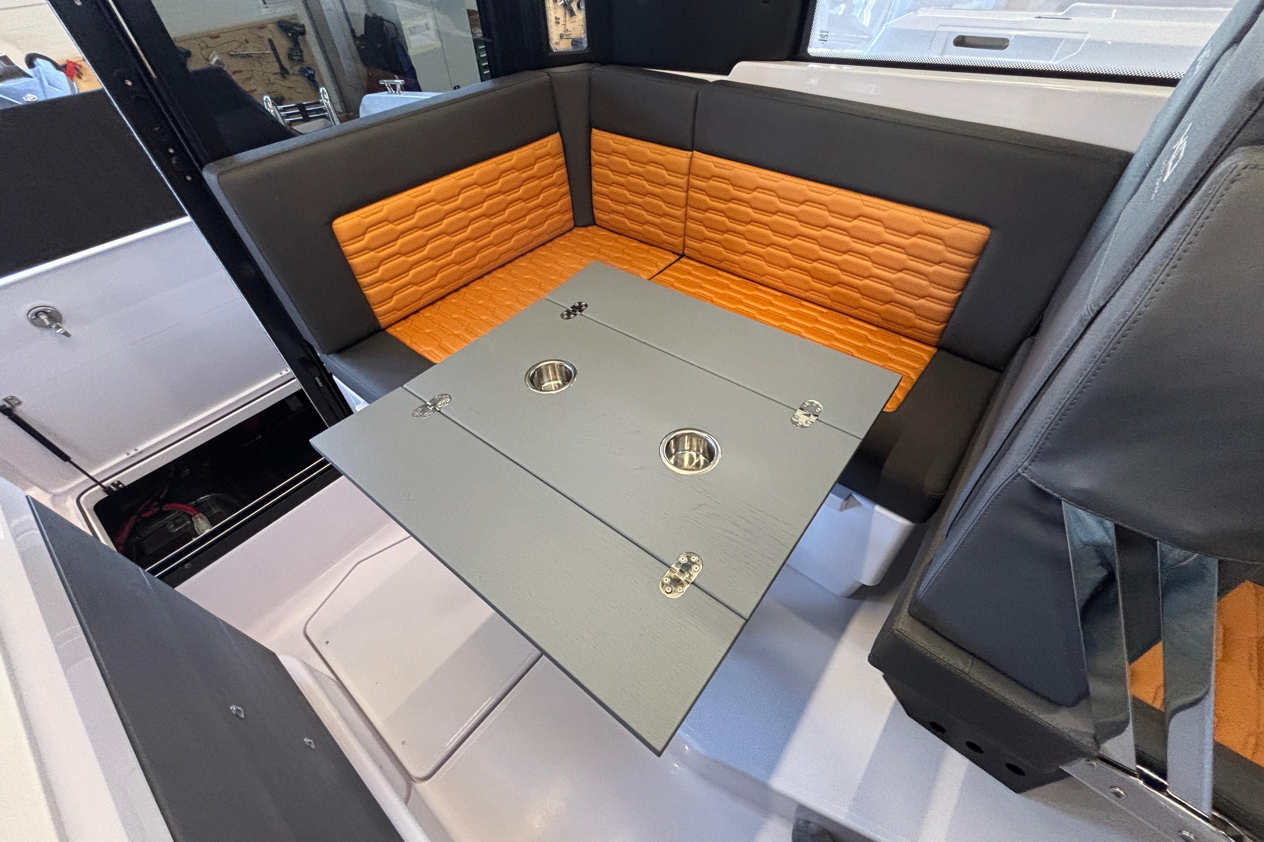 Interior of 2026 XO EXPLR 9 boat with stylish seating and foldable table.