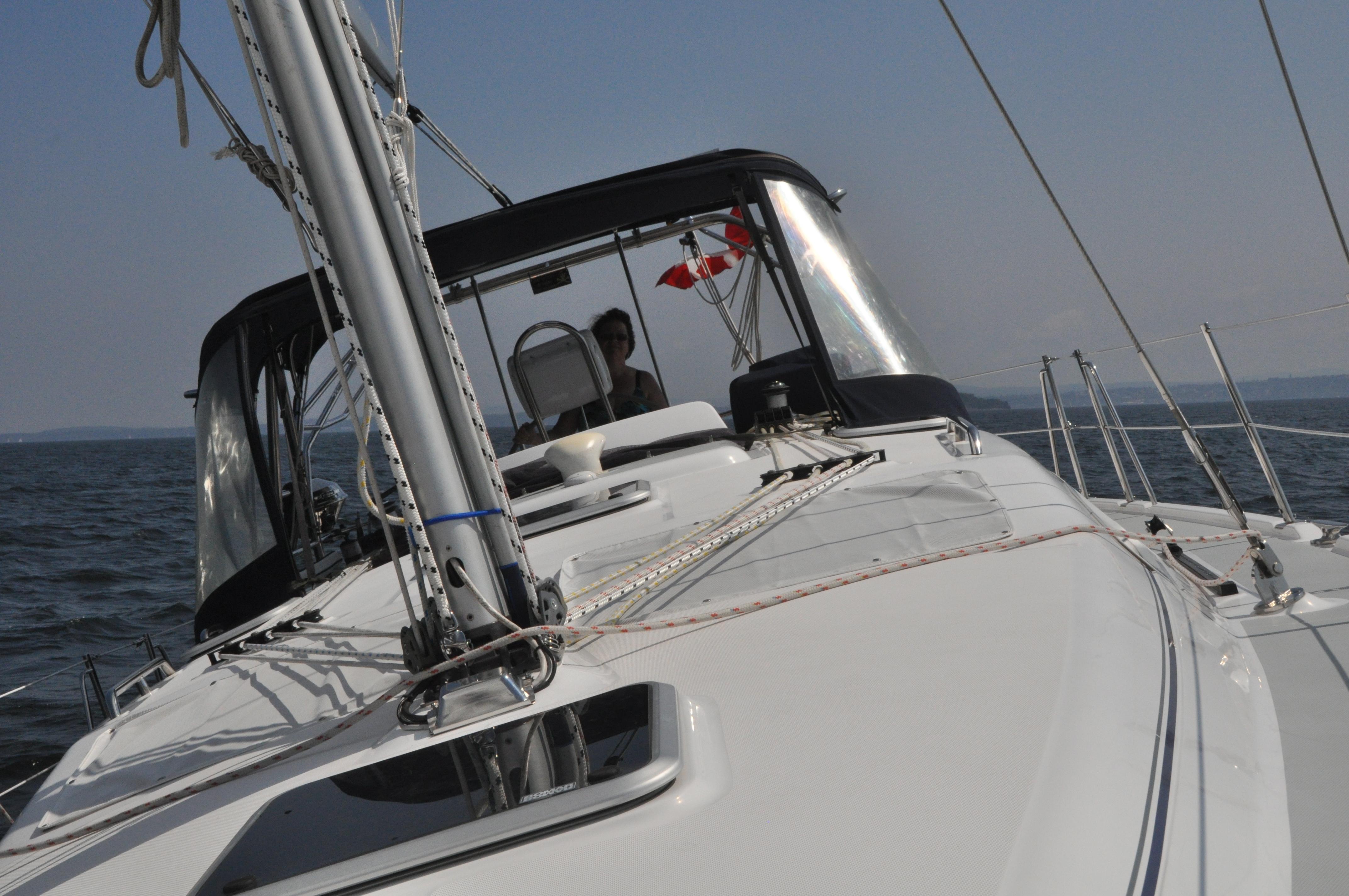 Sailing on a 2006 Hunter 41 yacht with Canadian flag in open waters.