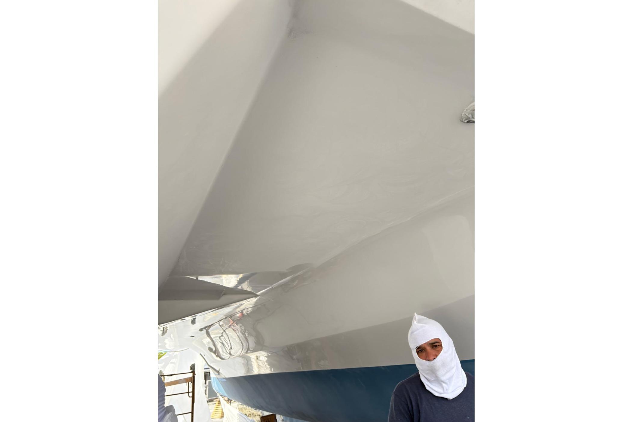Man standing near the hull of a 2008 Fountaine Pajot Salina 48 catamaran.