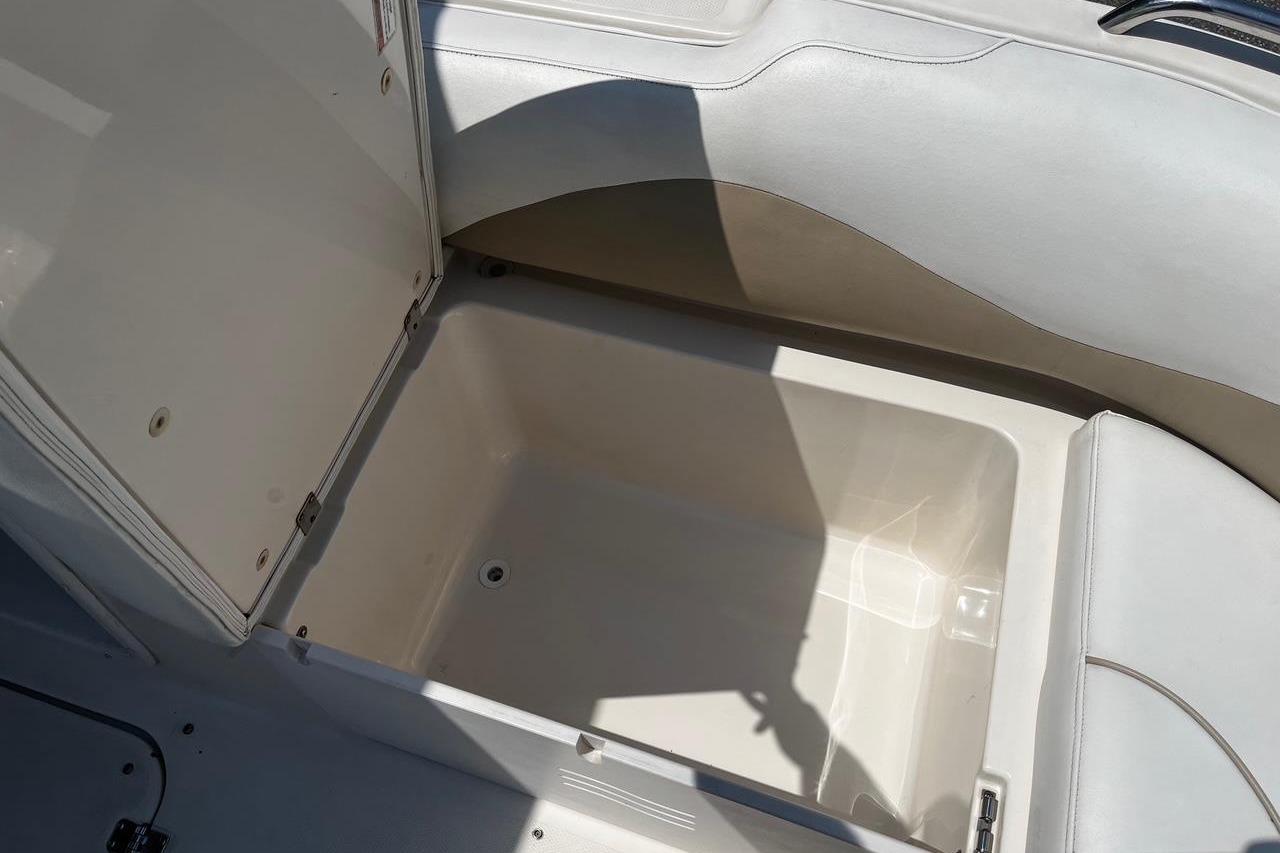 Open storage compartment in 2008 Hurricane FD202 boat, featuring white interior.