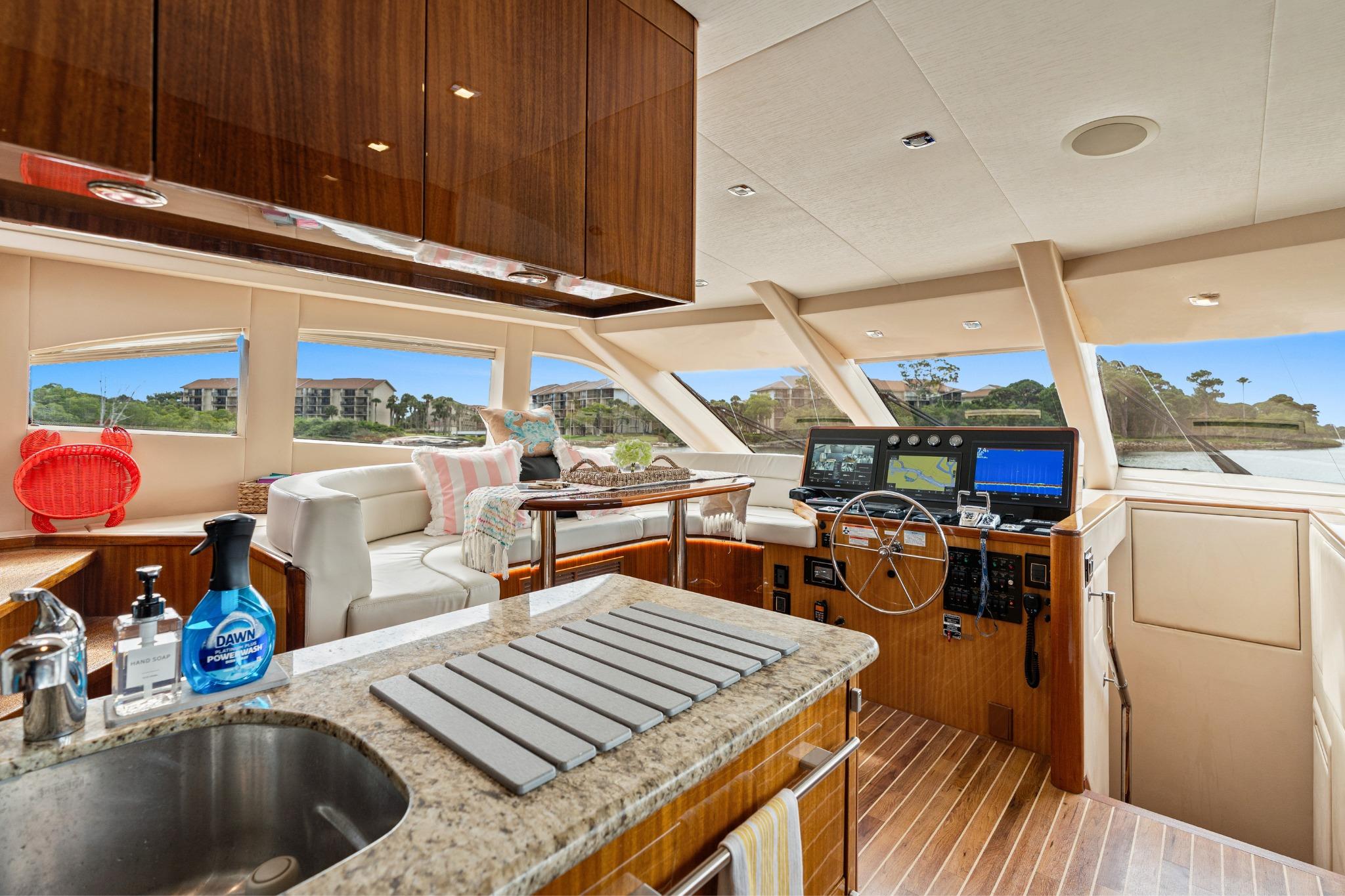 Luxurious interior of 2008 Hatteras 64 Motor Yacht with modern helm and seating area.