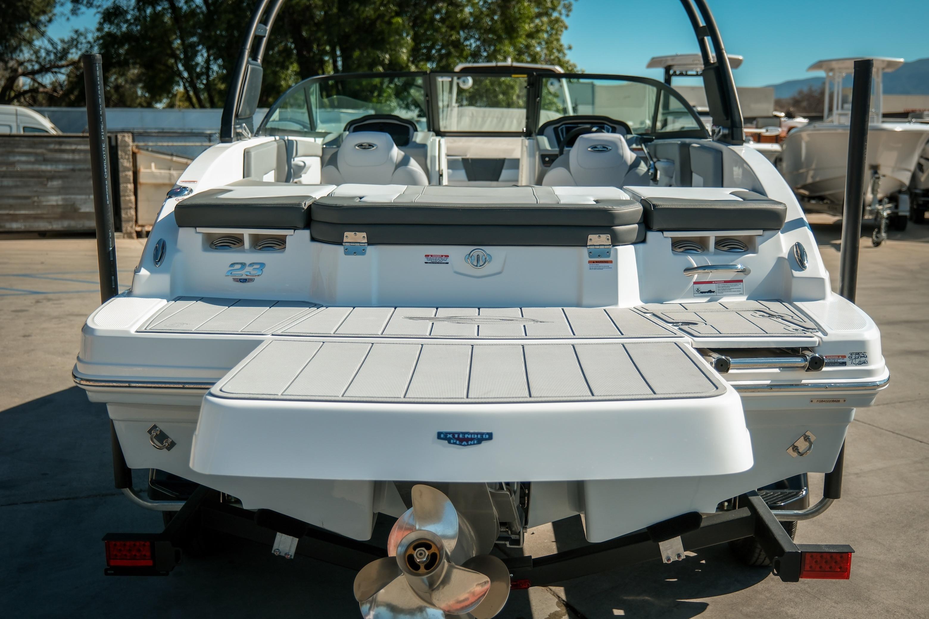 2026 Chaparral 23 SSi boat rear view with swim platform and seating.