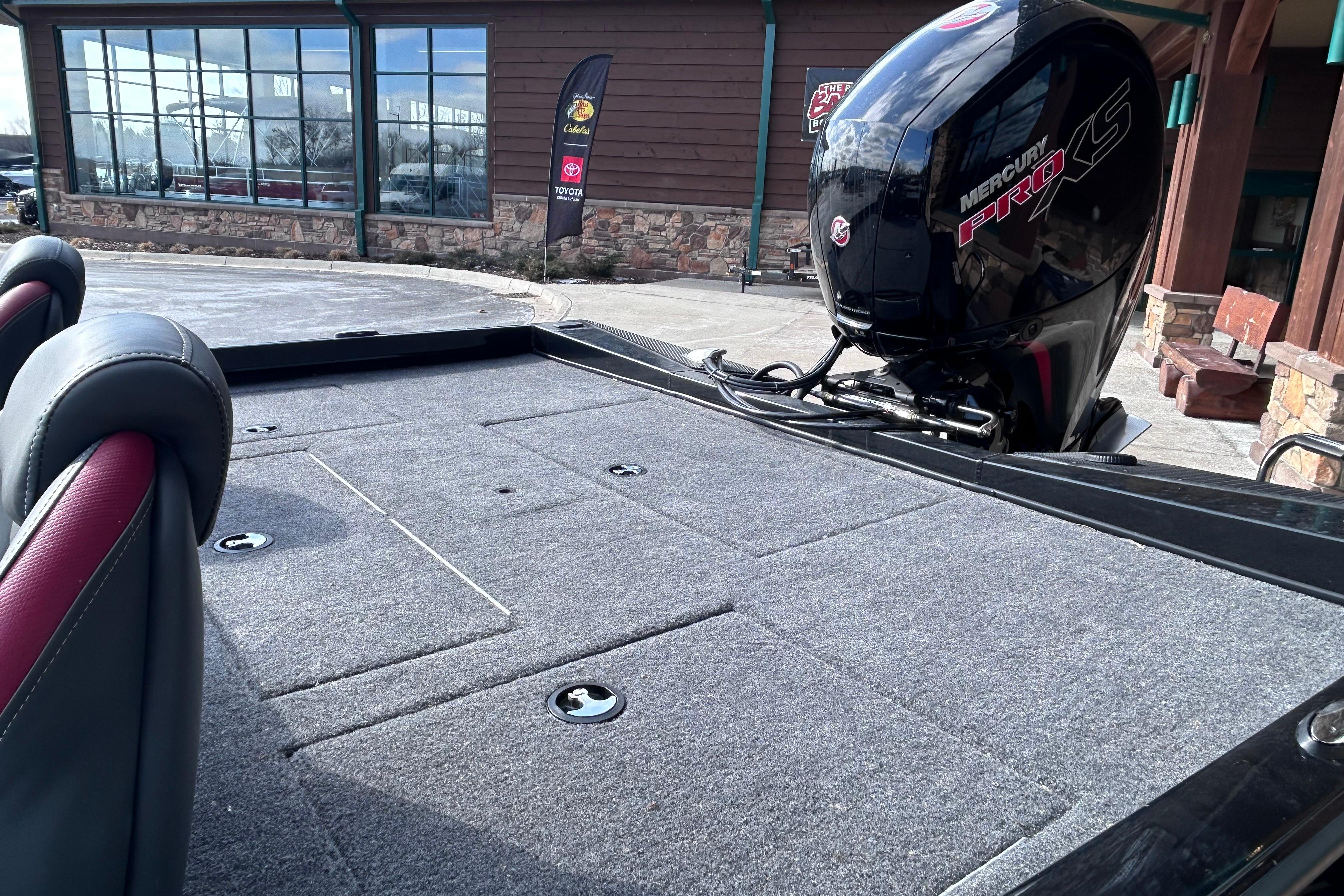 2025 Ranger RT198P boat with Mercury Pro XS engine, parked outside a showroom.
