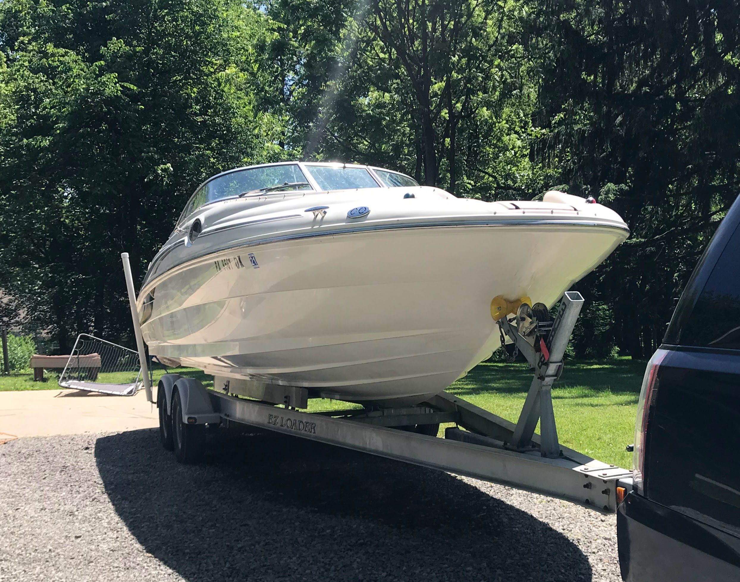 2001 Sea Ray 240 Sundeck on trailer outdoors.