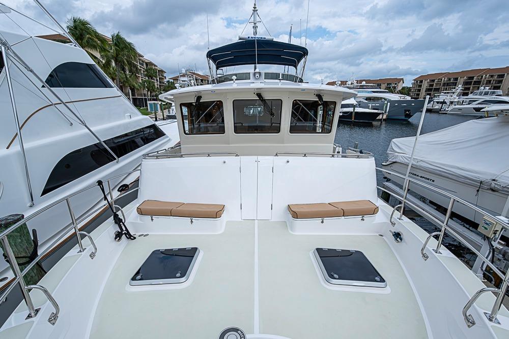 2016 Kadey-Krogen 52 yacht docked at marina, featuring spacious deck and seating area.
