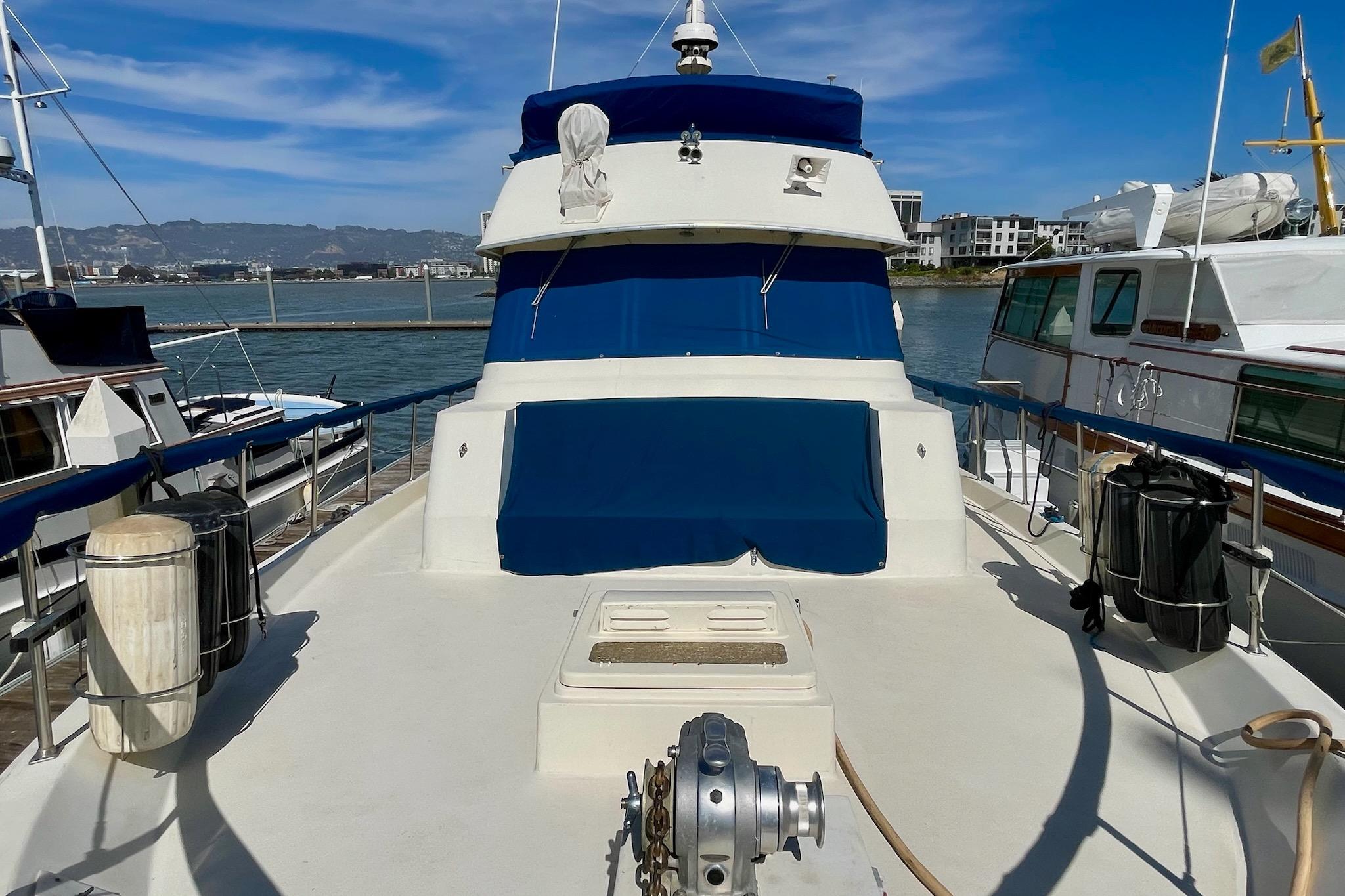 1976 Hatteras 48 Long Range Cruiser docked, featuring blue and white exterior.