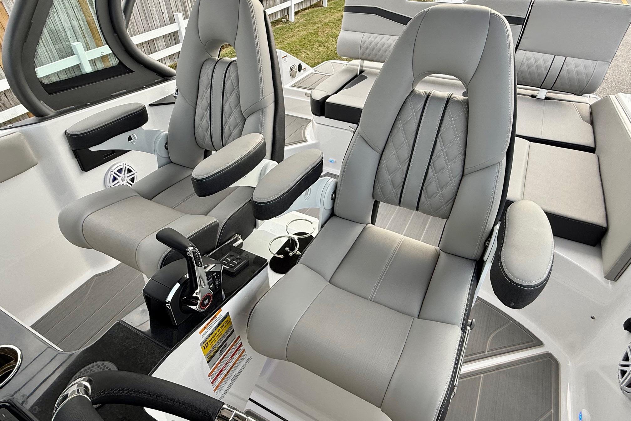 2026 Monterey Elite 25 OB boat interior with luxurious gray seating and modern controls.
