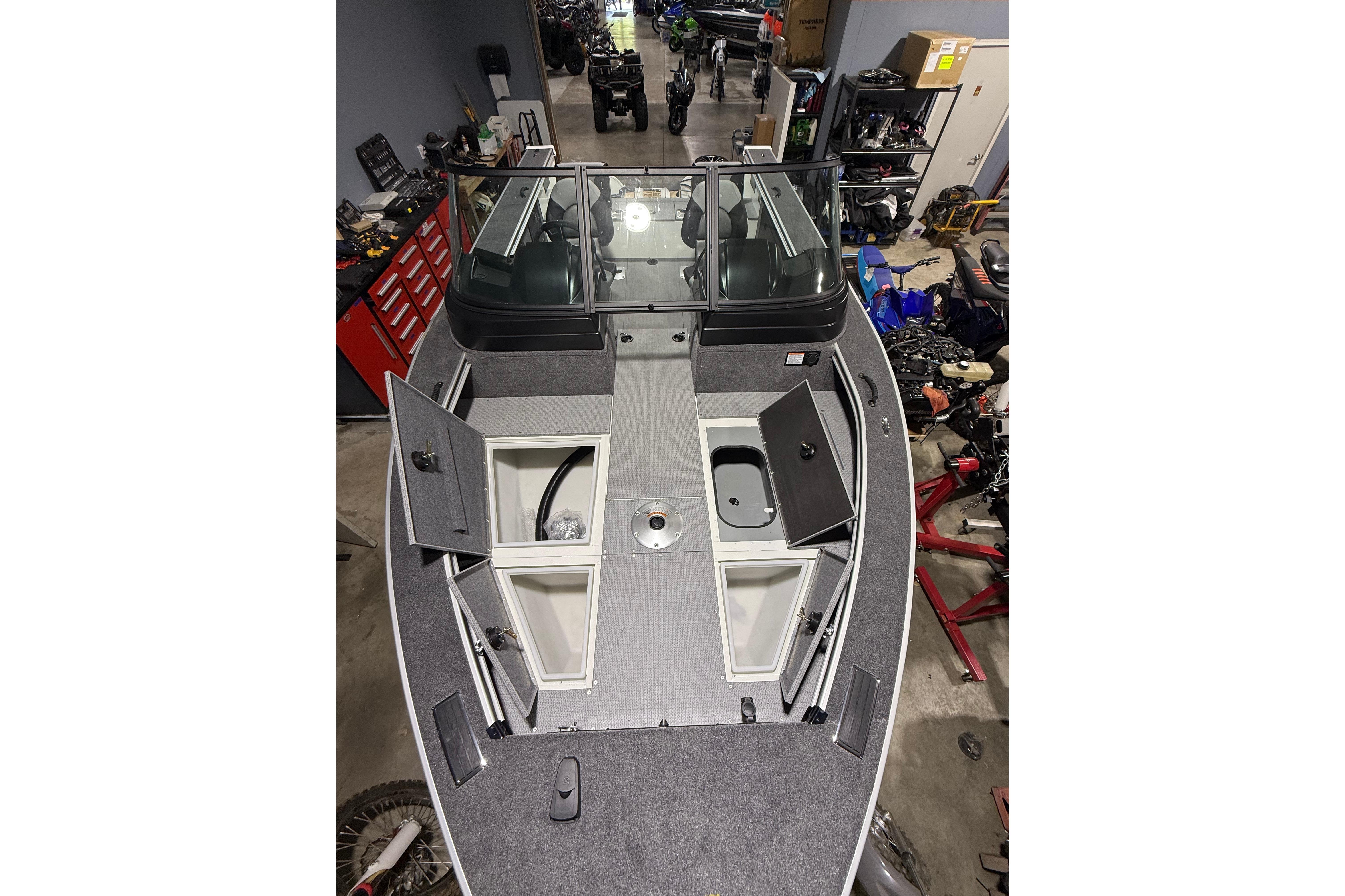 2025 G3 Angler V1850 SF boat interior with open storage compartments in a workshop setting.