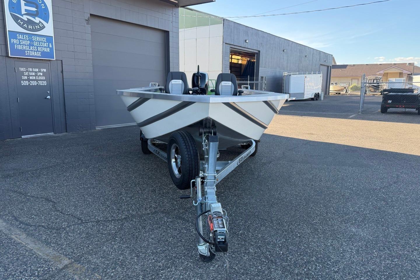 2026 Thunder Jet 209 Rush OT boat on trailer outside marine service shop.